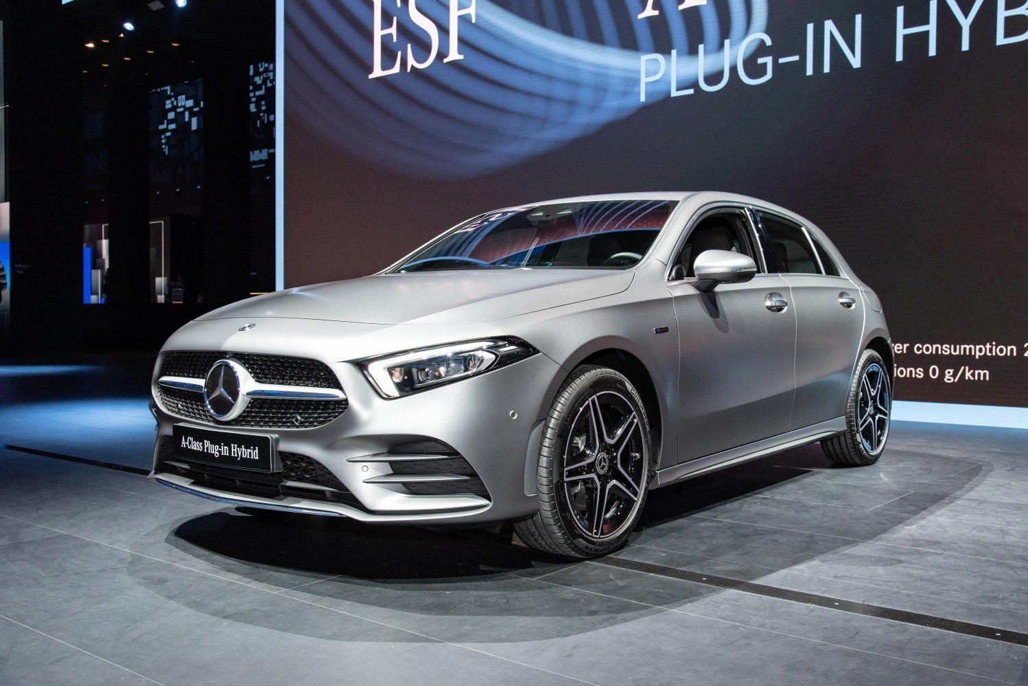 Front view of a modern plug-in hybrid hatchback with LED headlights and distinctive grille