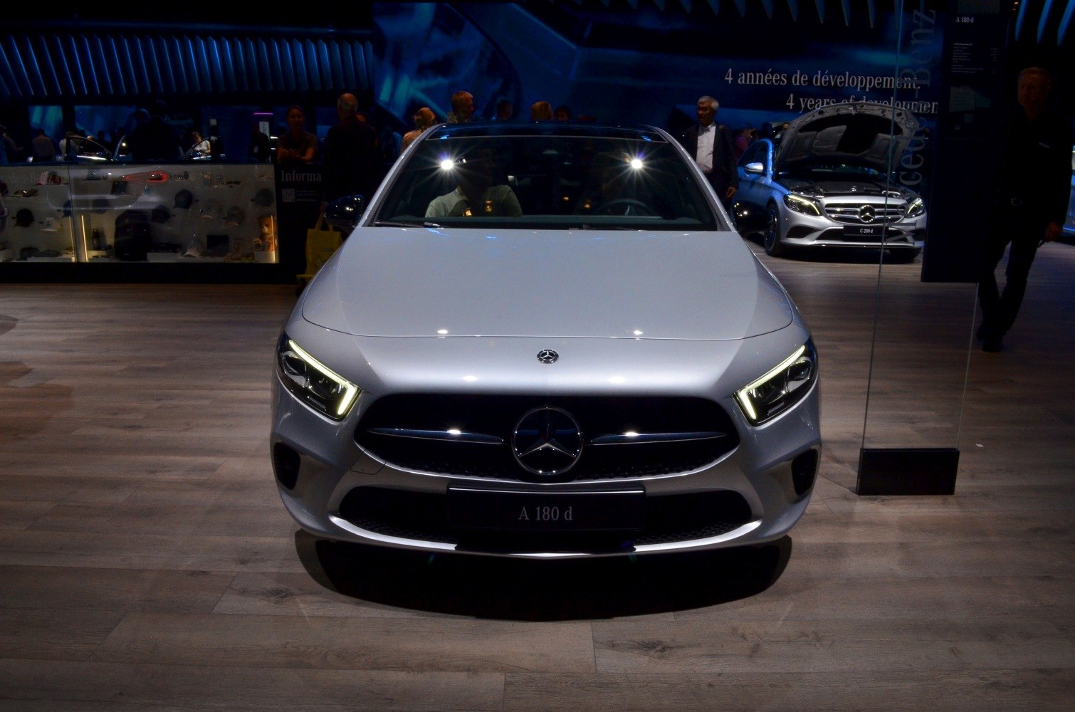Front view with illuminated LED headlights and distinctive grille.