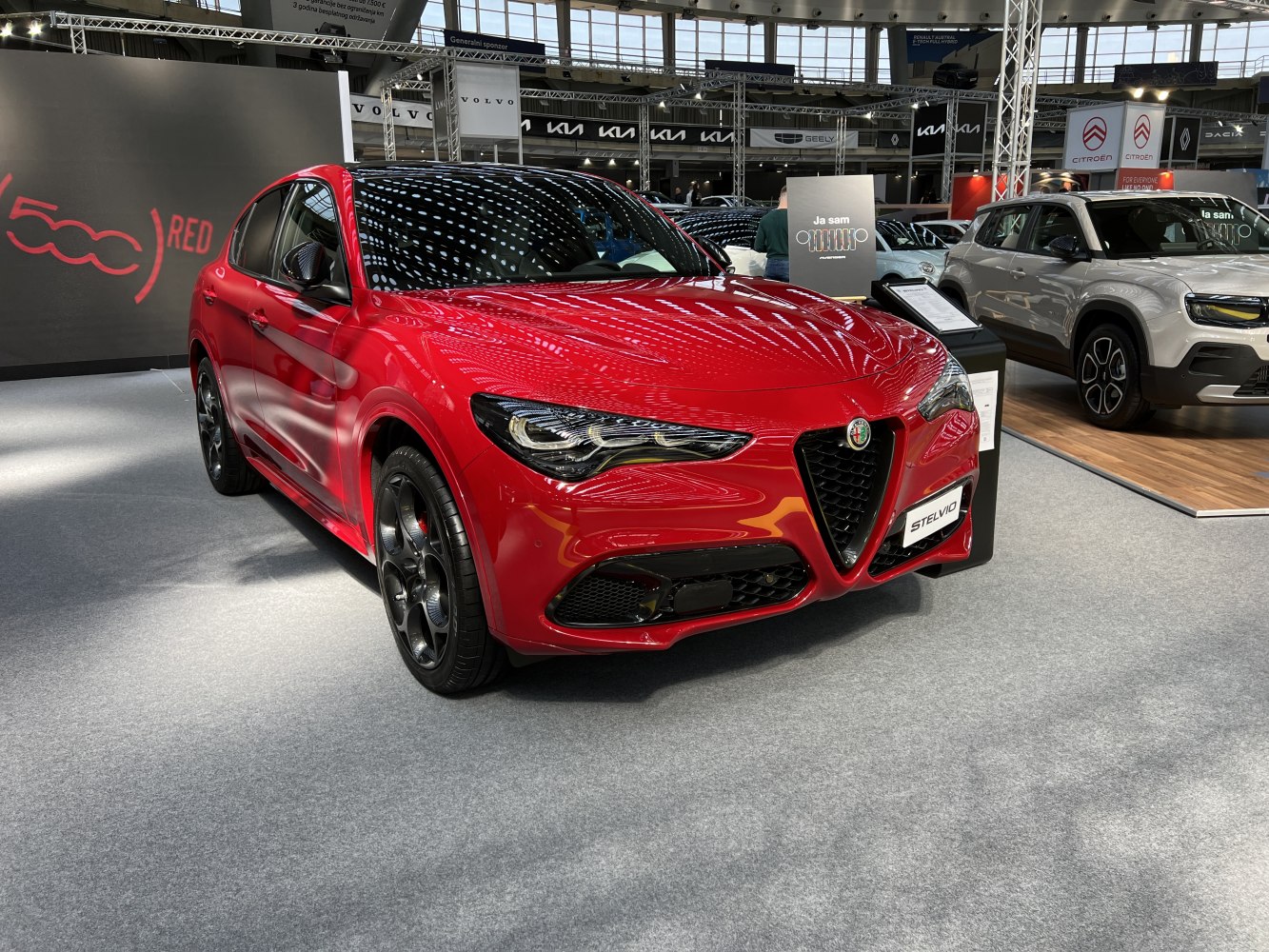 Front view of red SUV with triangular grille and sleek headlights
