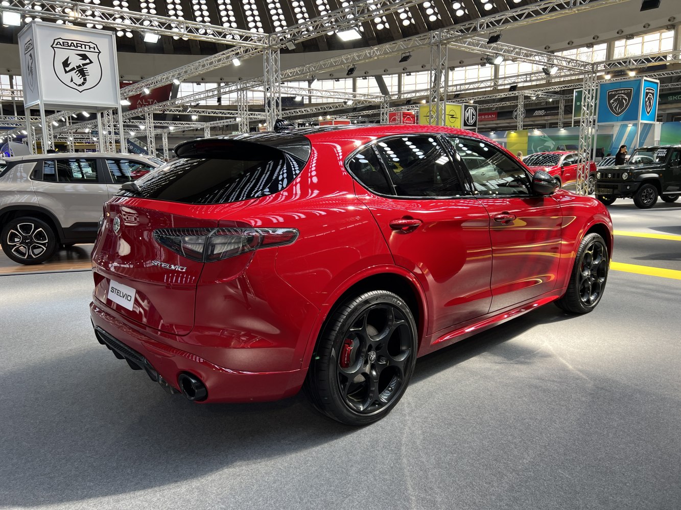 Red SUV rear three-quarter view with black alloy wheels