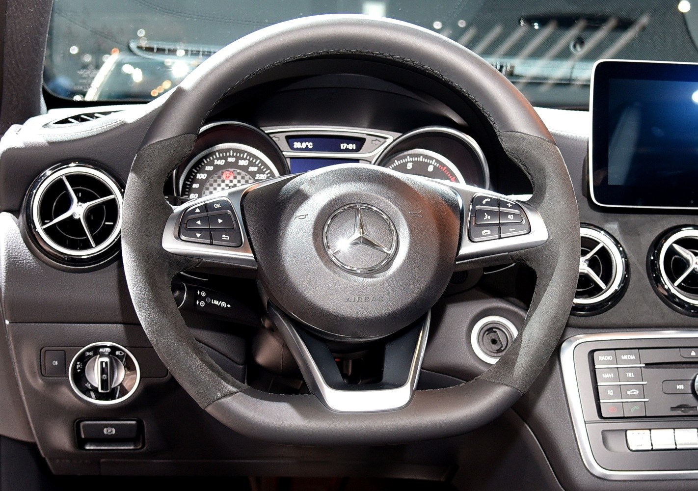 Steering wheel with controls and dashboard with digital displays