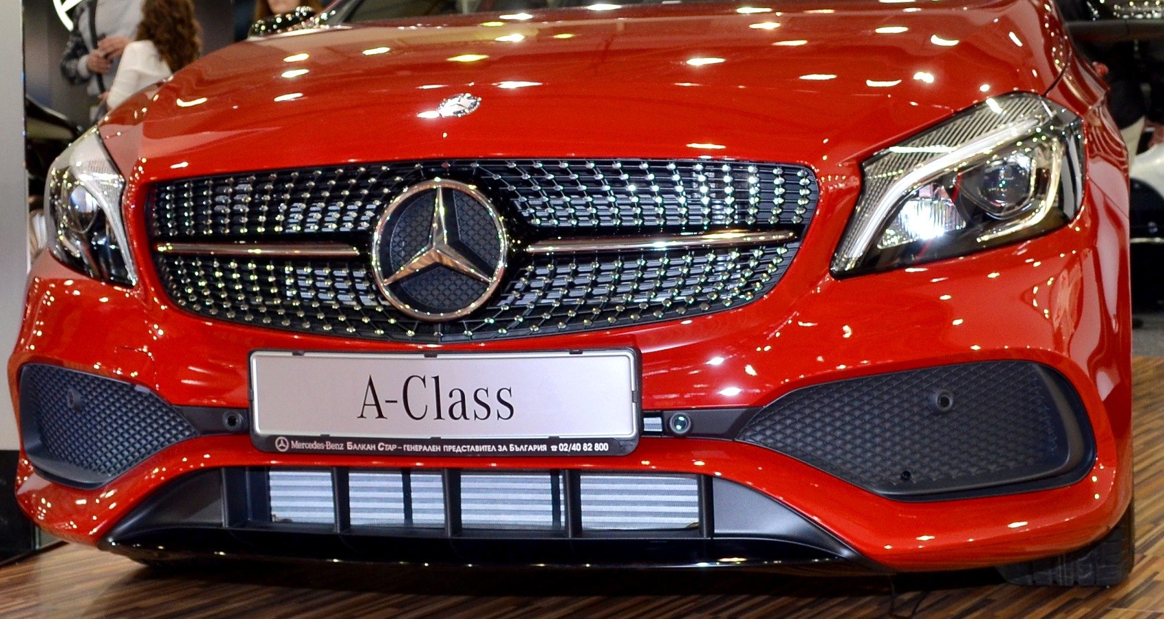 Front grille and headlight of a car with prominent logo