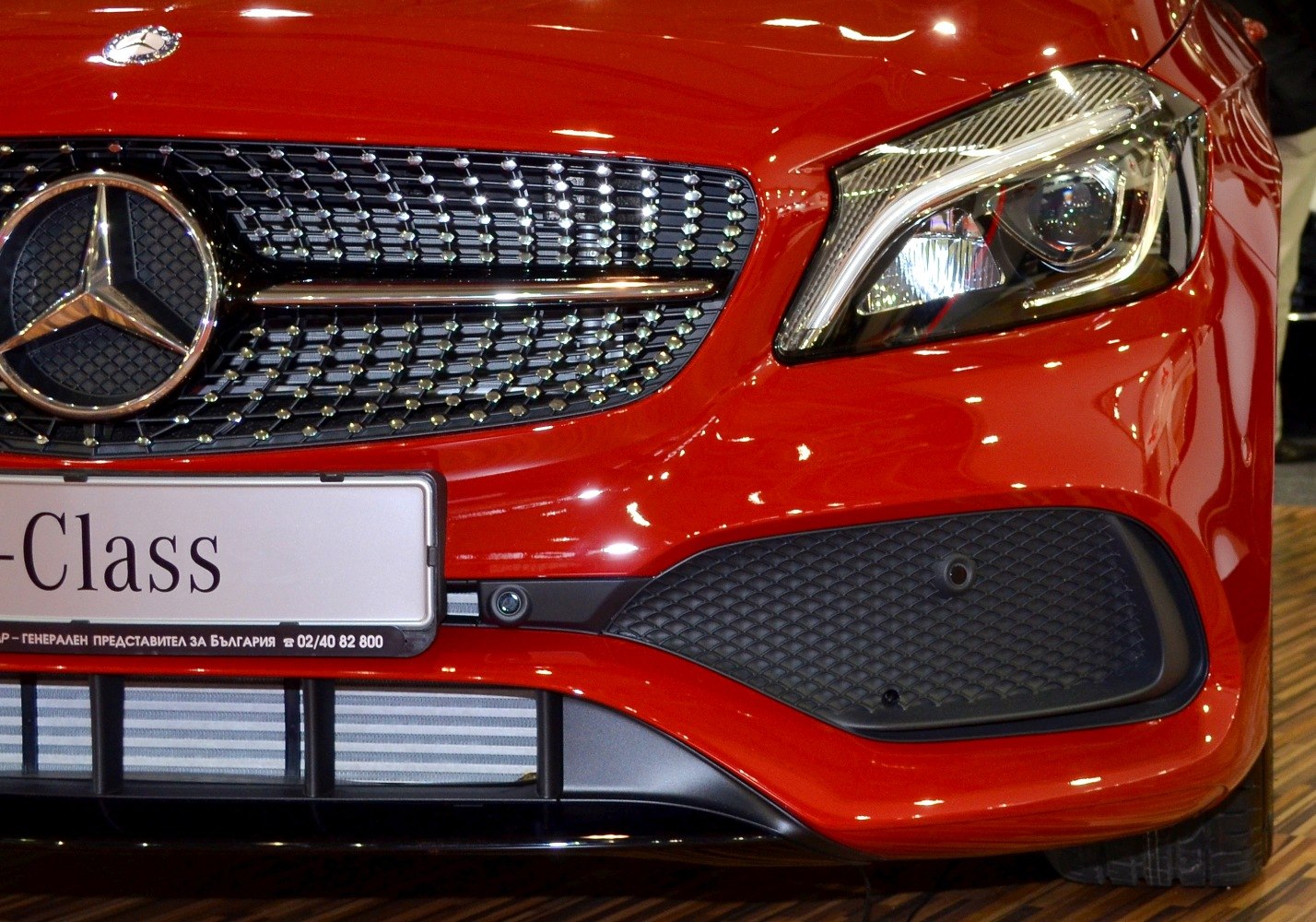 Close-up of front grille and headlight with distinct pattern and sharp lines