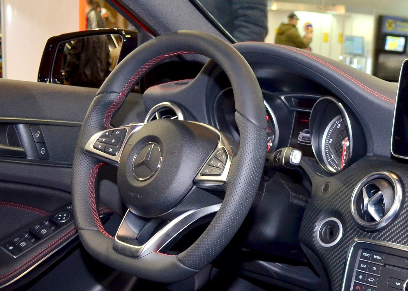 Steering wheel and dashboard with red stitching and instrument cluster
