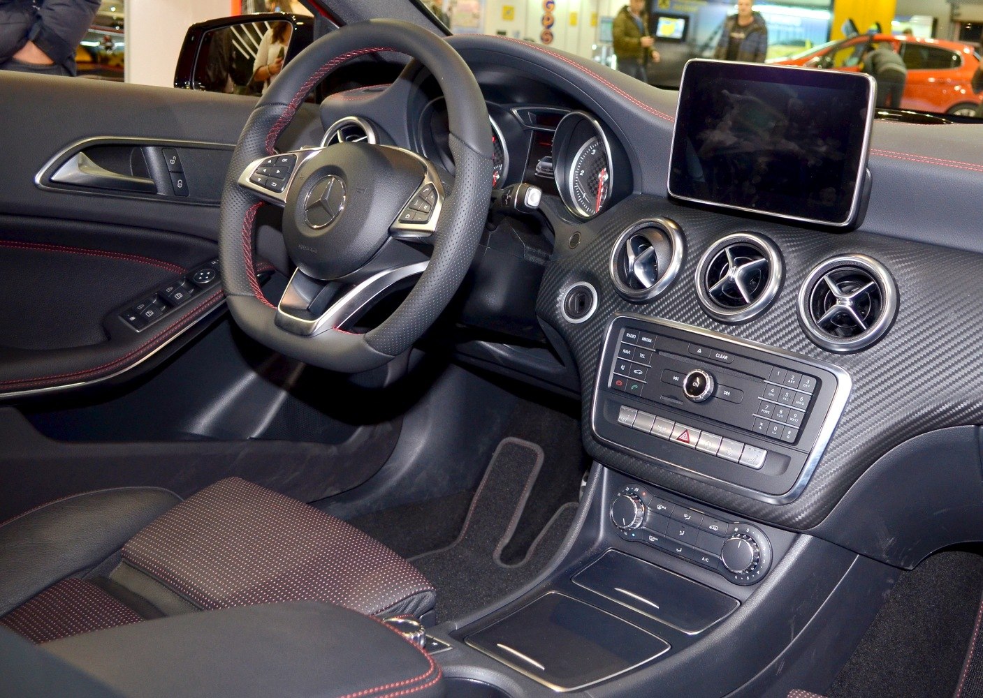 Steering wheel and dashboard with infotainment screen and air vents