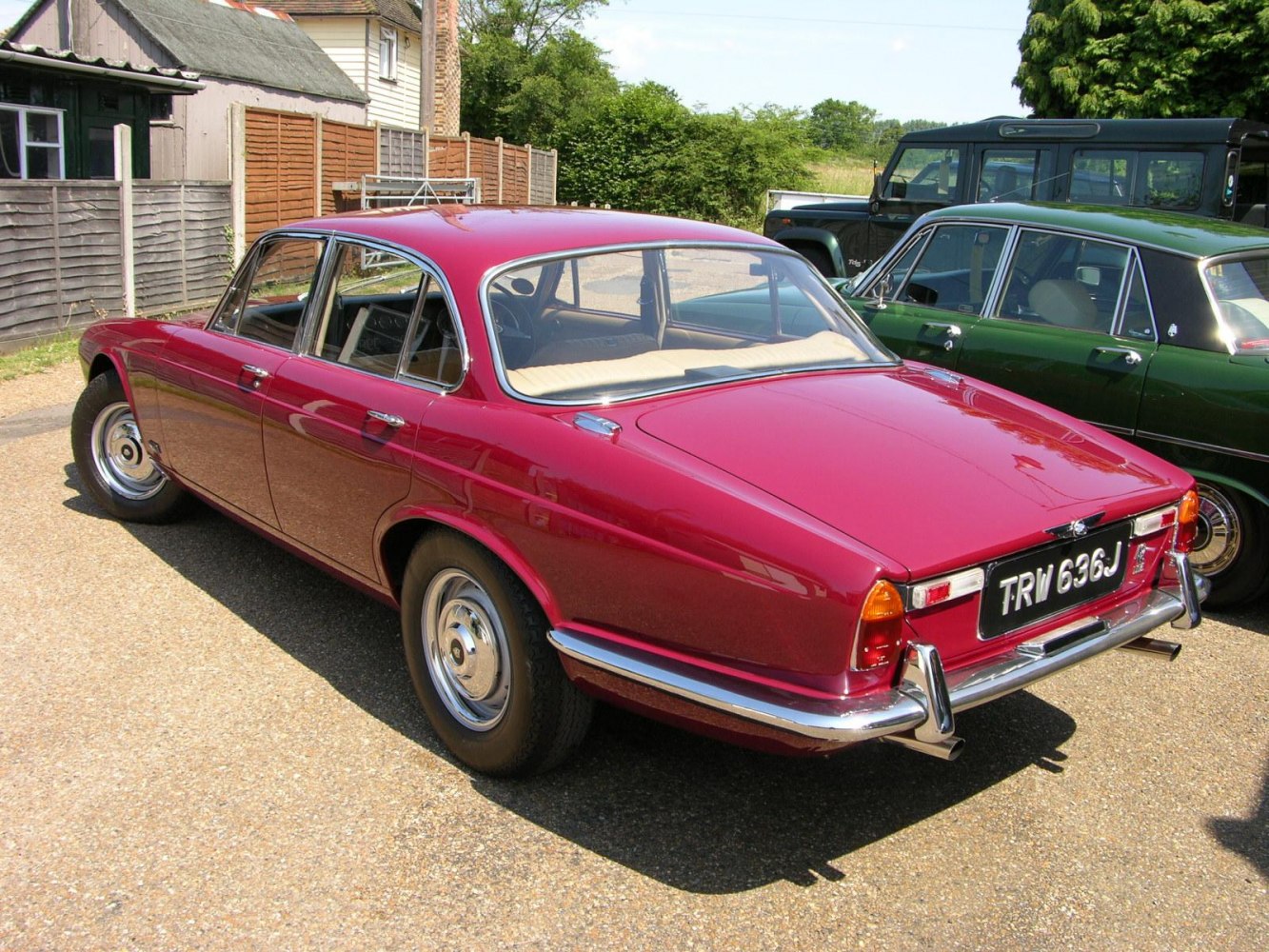 Vintage red sedan rear with chrome trim and classic taillights