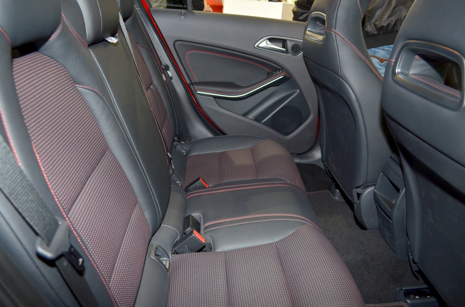 Rear passenger seating with red contrast stitching and door panel design