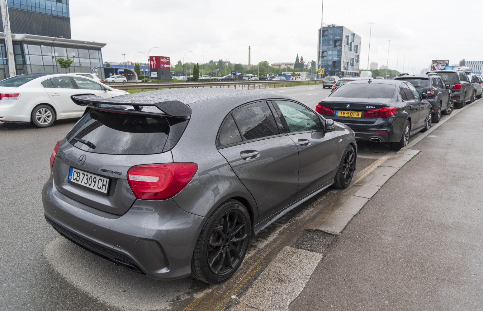 Gray sporty hatchback with rear spoiler and black wheels