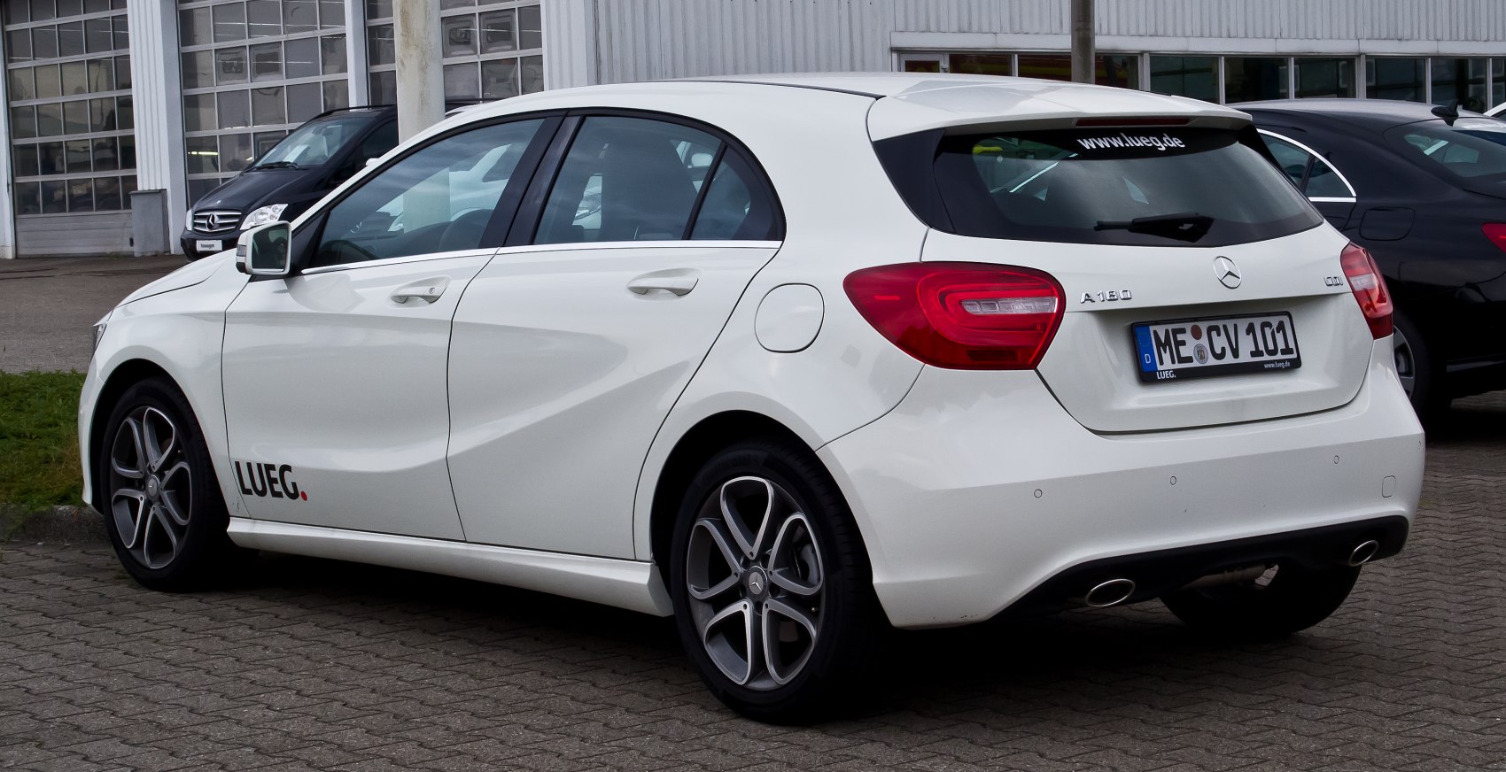 Rear and side profile of white hatchback with sporty alloy wheels and distinctive taillights