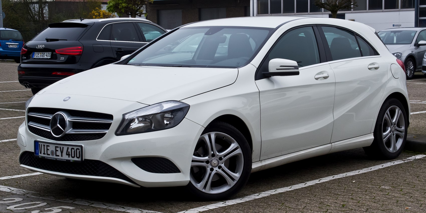 White hatchback front-side view with grille and alloy wheels