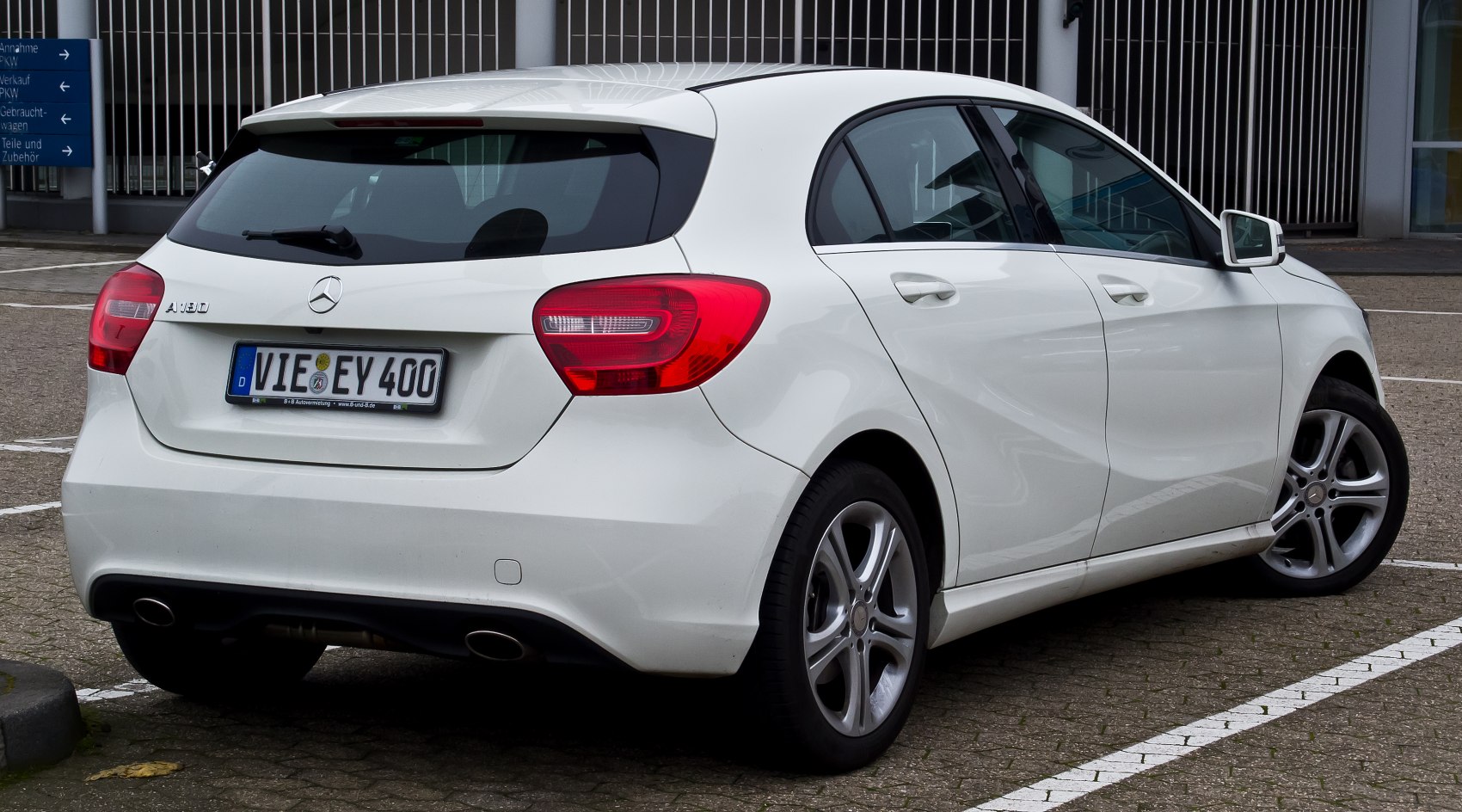 White five-door hatchback with dual exhaust and rear tail lights