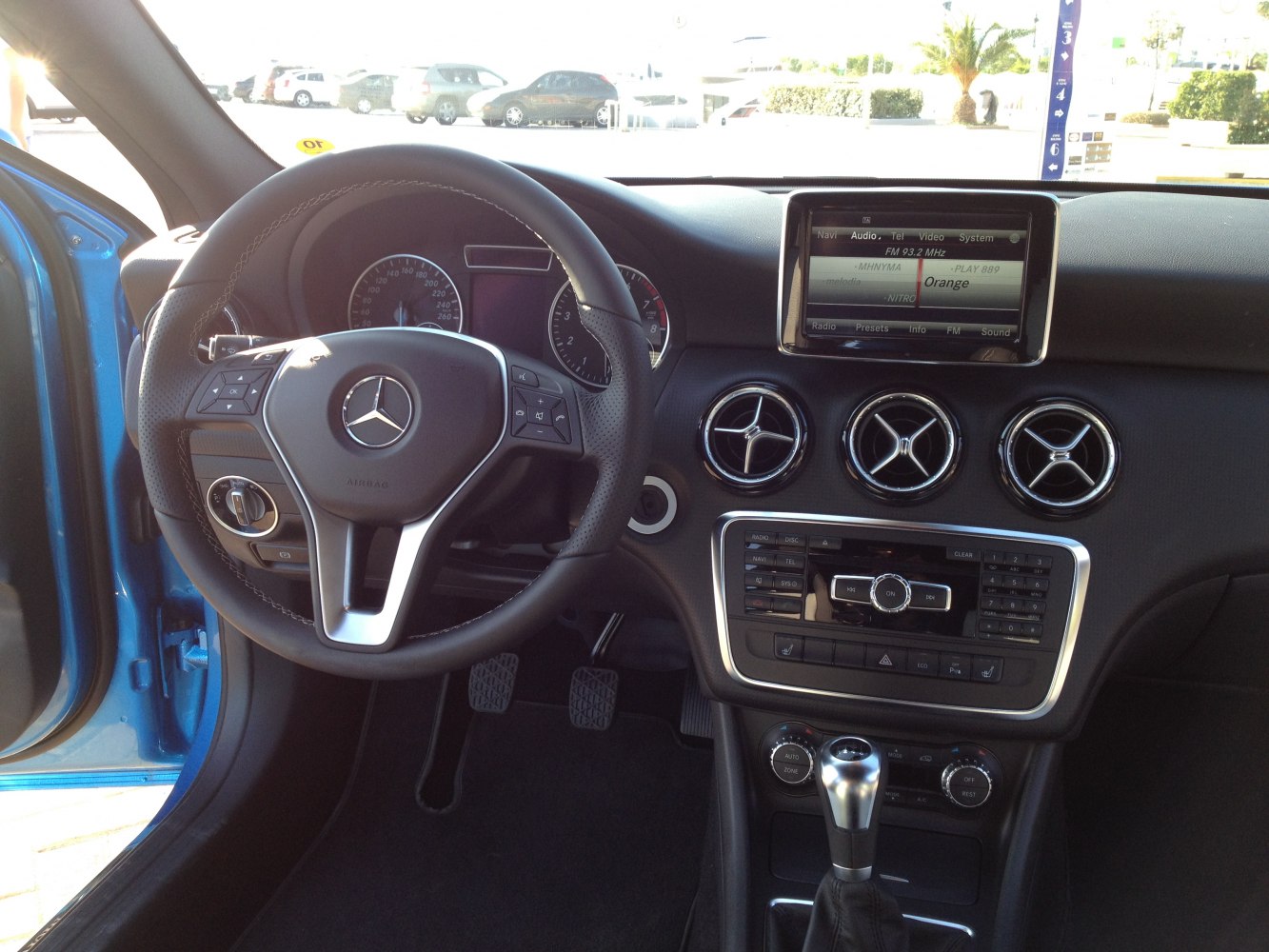 Interior dashboard and steering wheel with infotainment and air vents