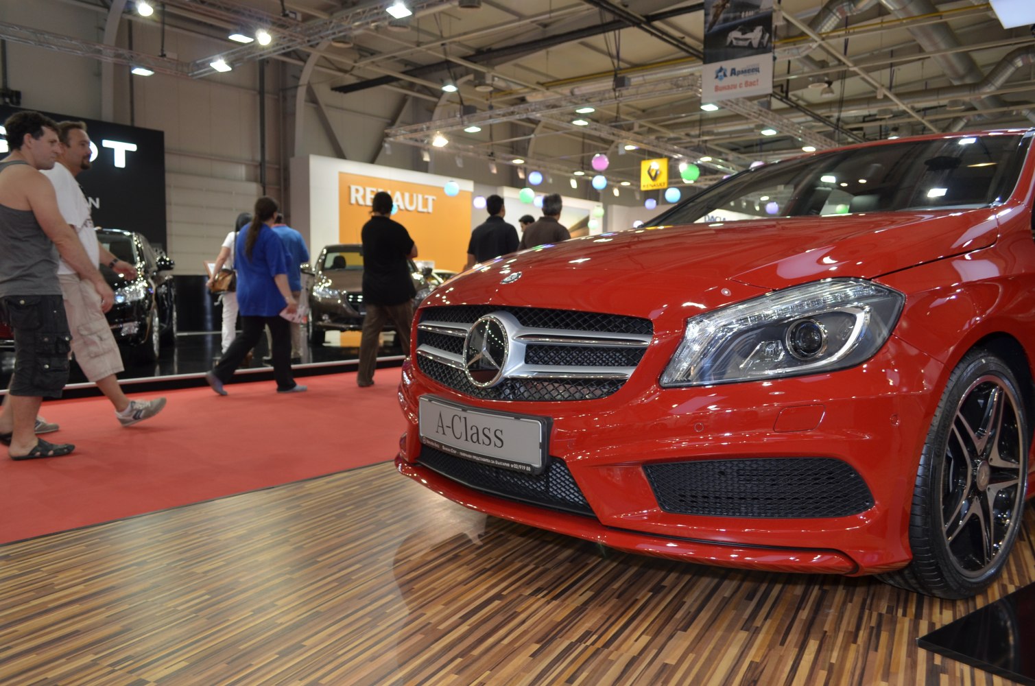 Close-up of red car front grille and headlight