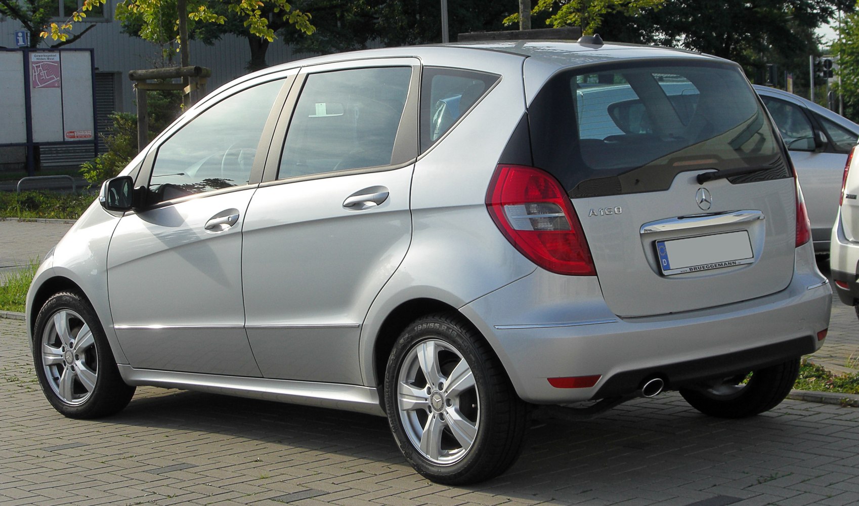 Silver compact hatchback rear side with alloy wheels and taillight design