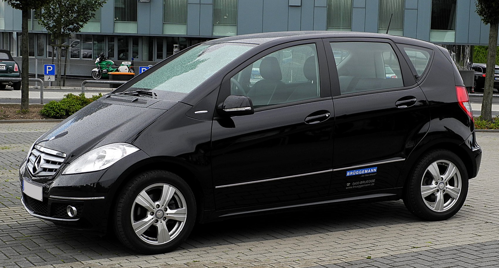 Side view of a compact hatchback with alloy wheels and sleek design.