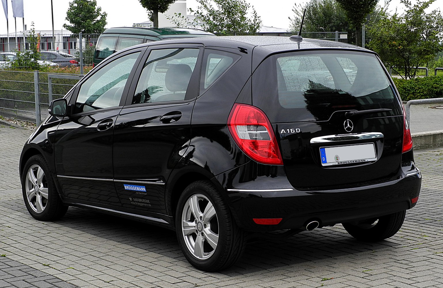 Rear three-quarter view of a compact black hatchback with distinct taillights and alloy wheels.