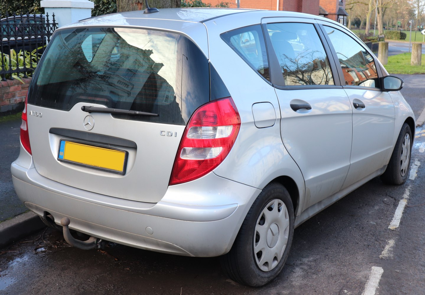 Rear view of a compact hatchback with tailgate and vertical taillights