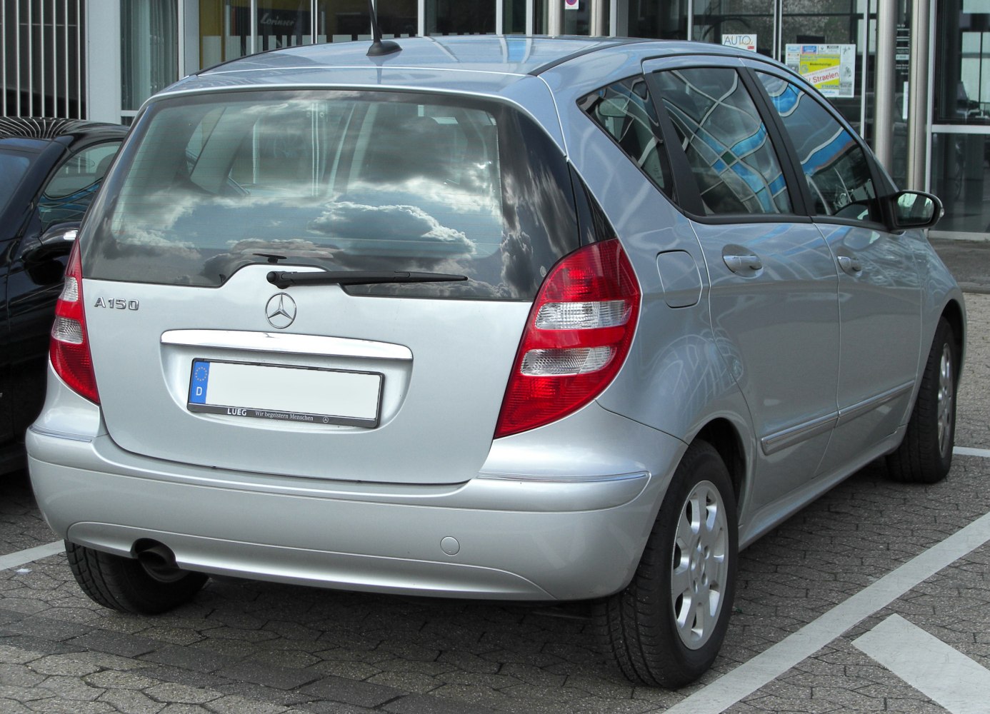 Silver compact hatchback rear with distinctive taillights and rear windshield