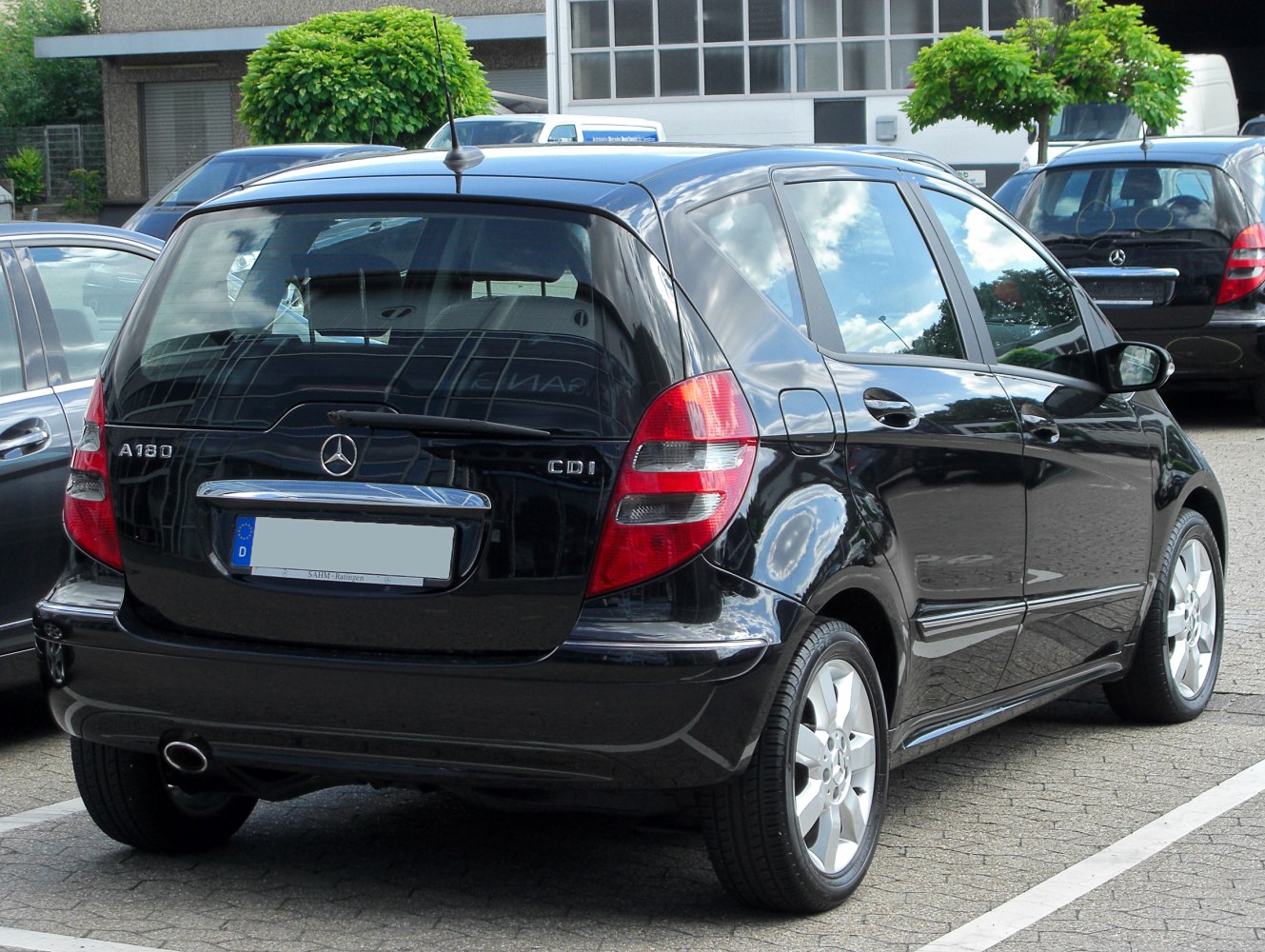 Rear and side view of a small five-door hatchback with rear window wiper.