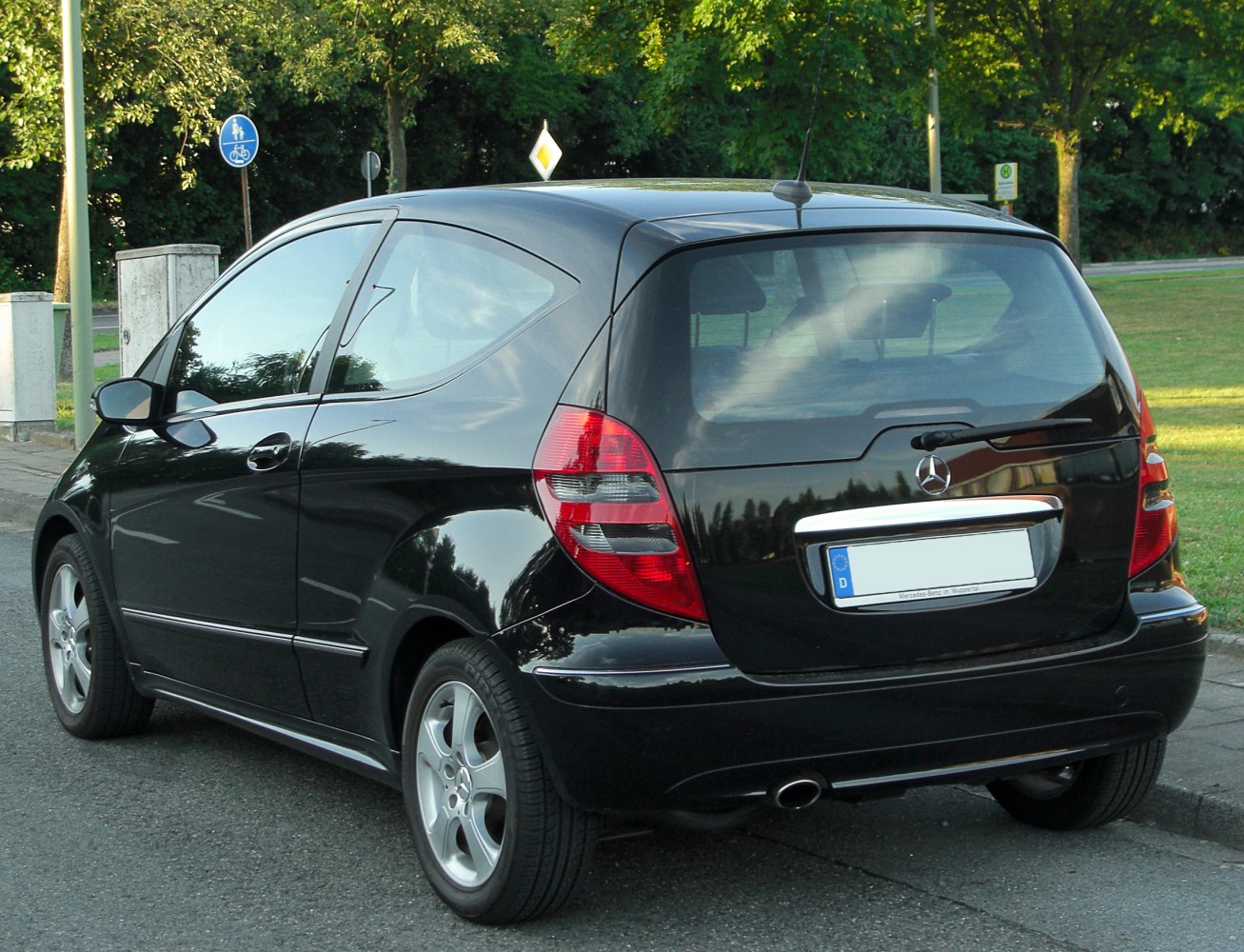 Rear side view of compact hatchback with taillights and rear window