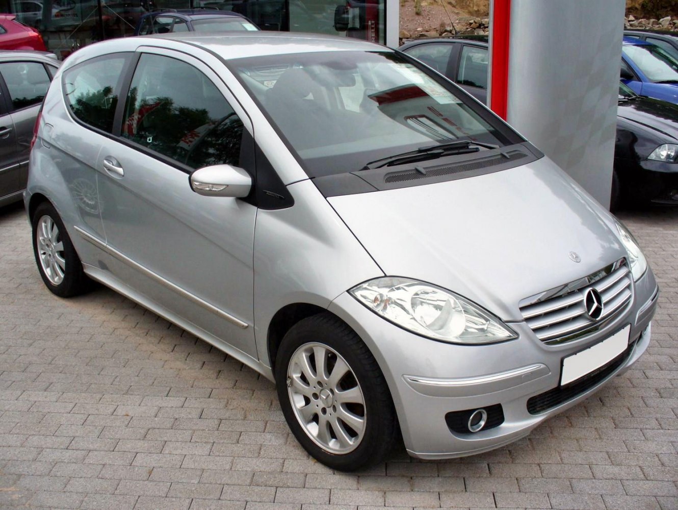 Compact silver hatchback with distinctive front grille and headlights