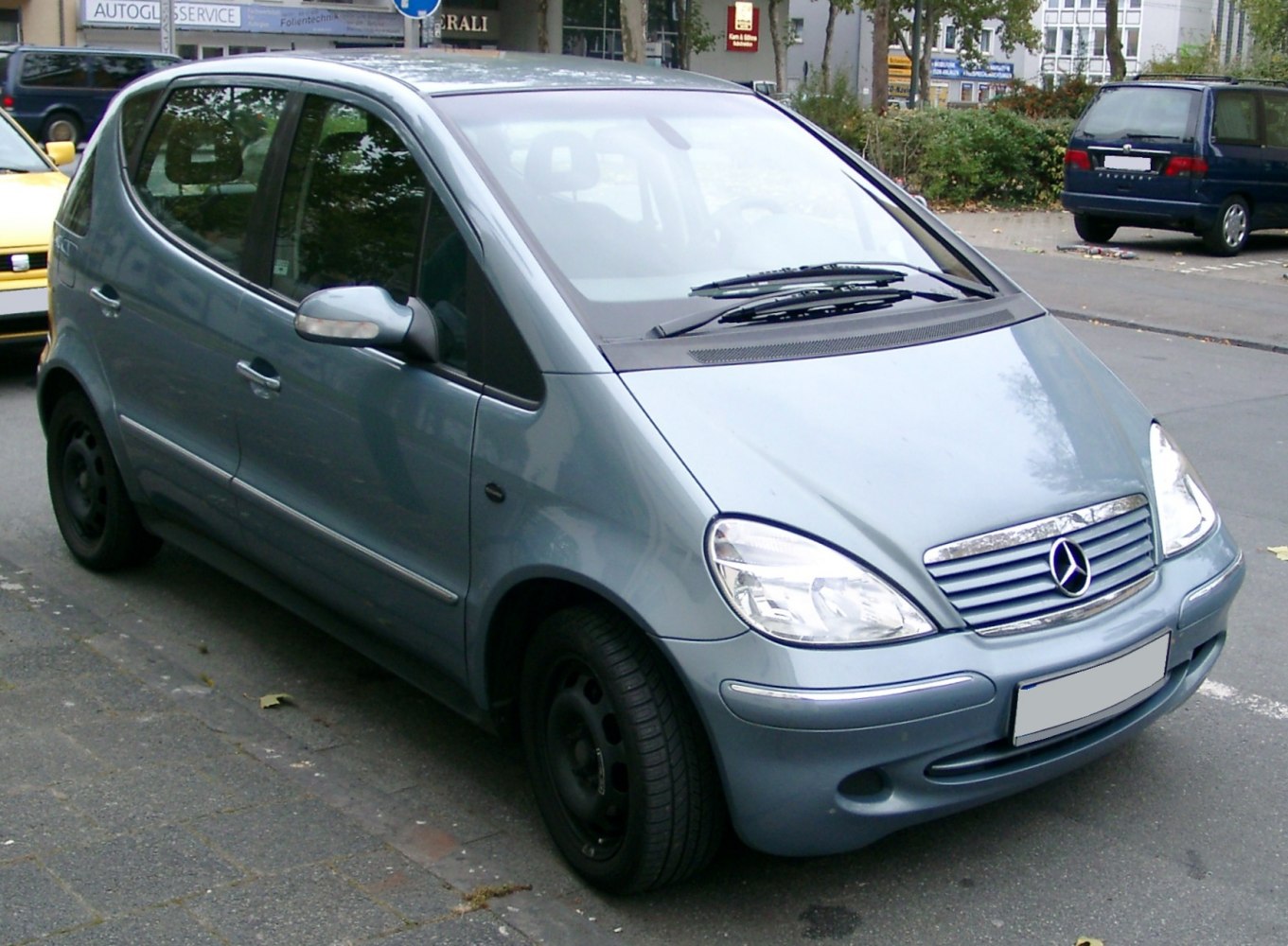 Compact hatchback with rounded headlights and horizontal grille slats.