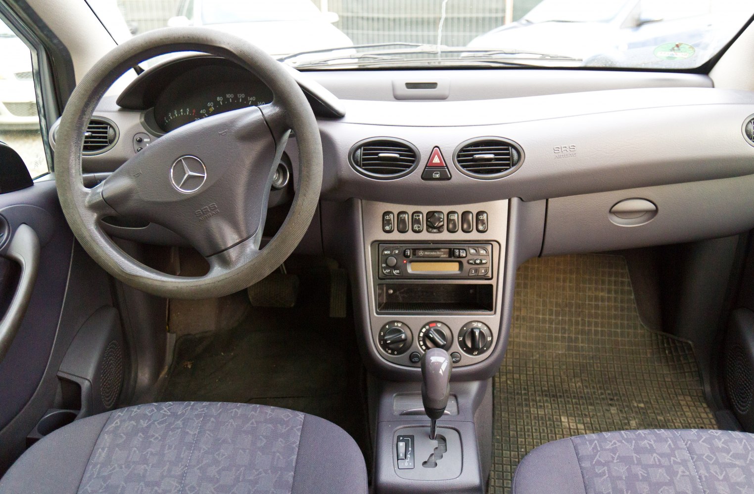 Car dashboard and steering wheel with center console controls