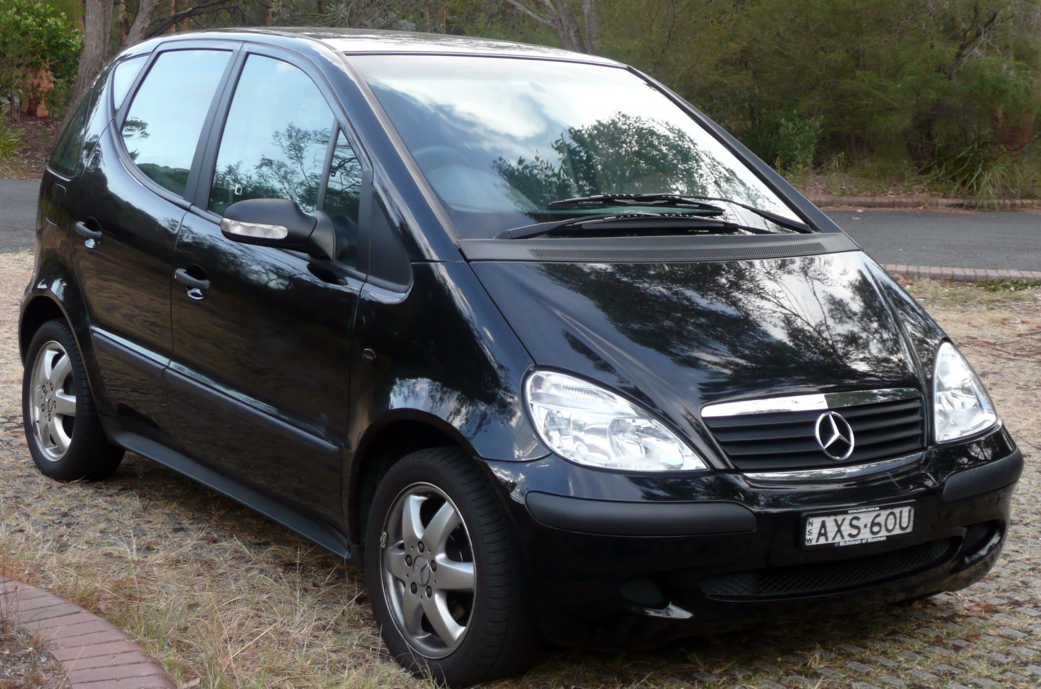 Front and side of compact hatchback with chrome grille and alloy wheels