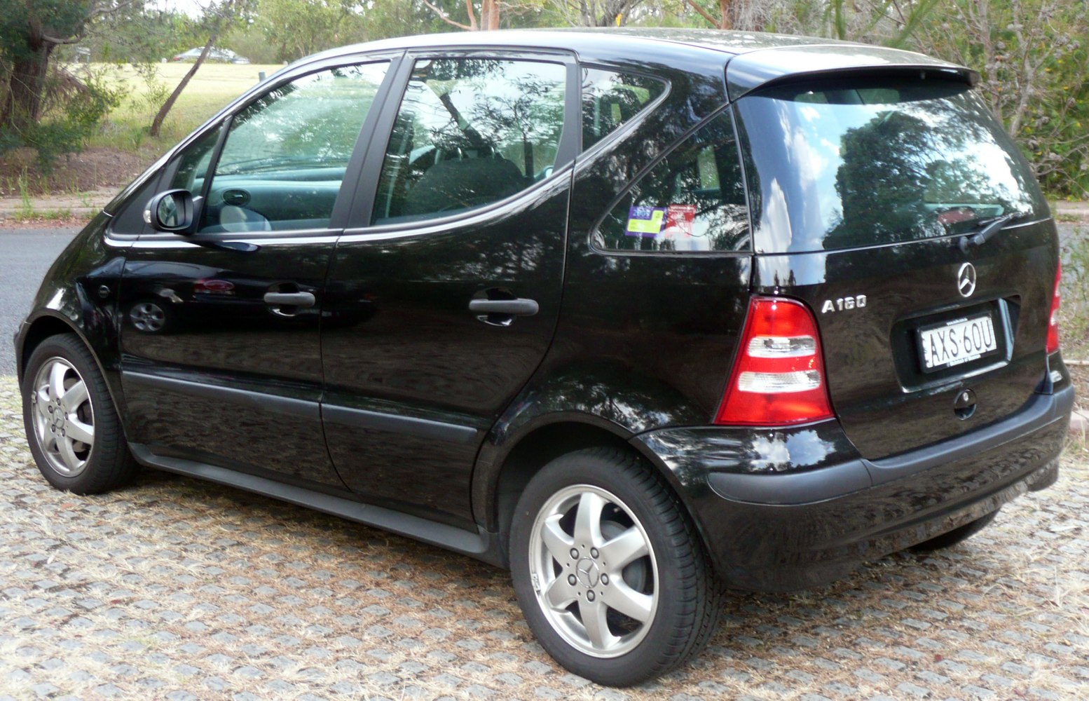 Rear and side view of compact hatchback with five-spoke wheels