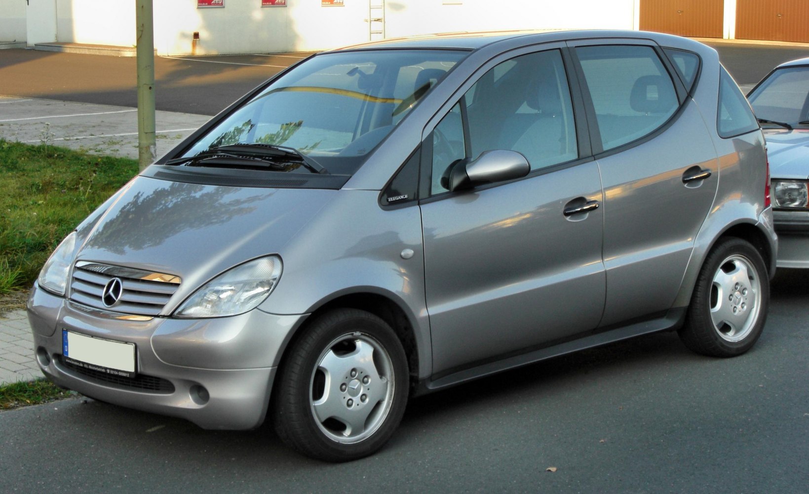 Silver compact hatchback with rounded design and five-spoke wheels