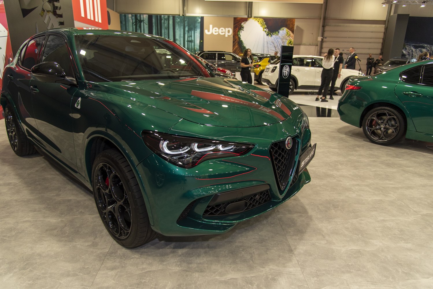Front view of a green SUV with distinctive headlights and sporty grille