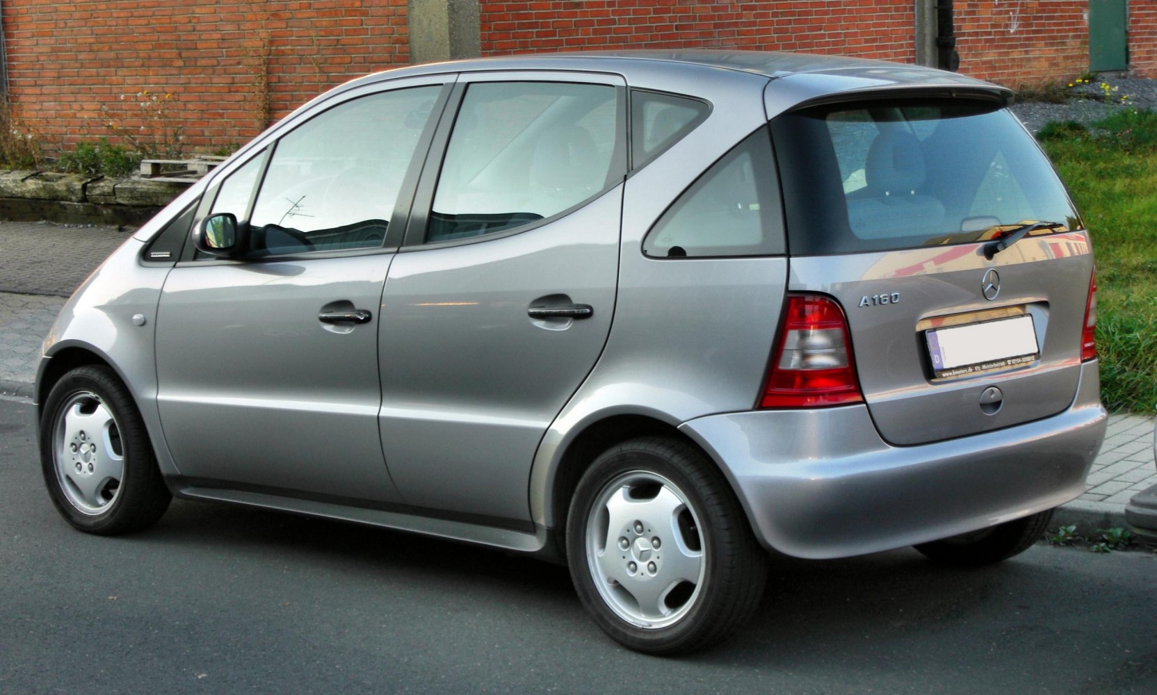 Silver compact hatchback with distinct rear side profile and curved rear window
