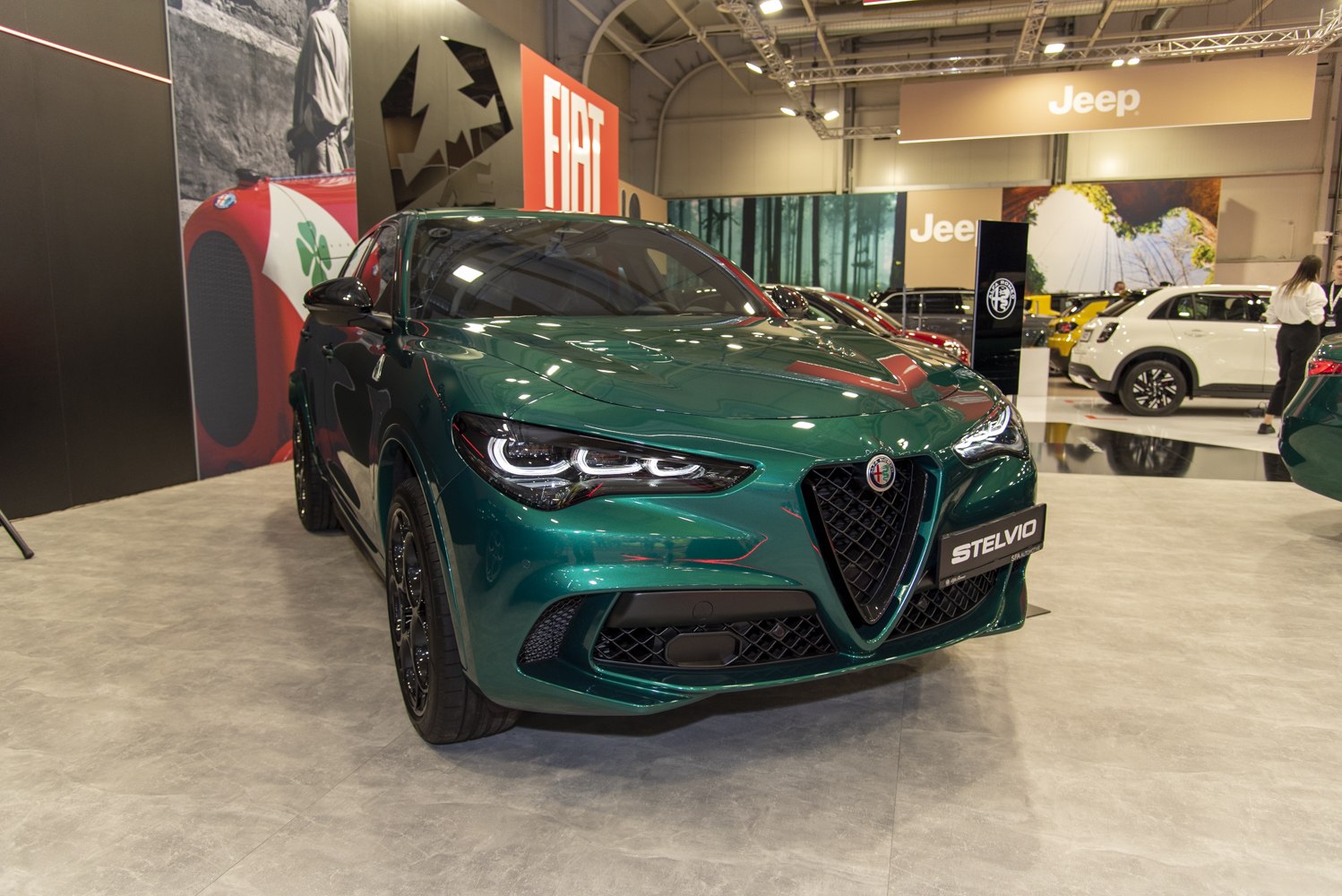 Sleek LED headlights and sporty front grille of a green modern SUV
