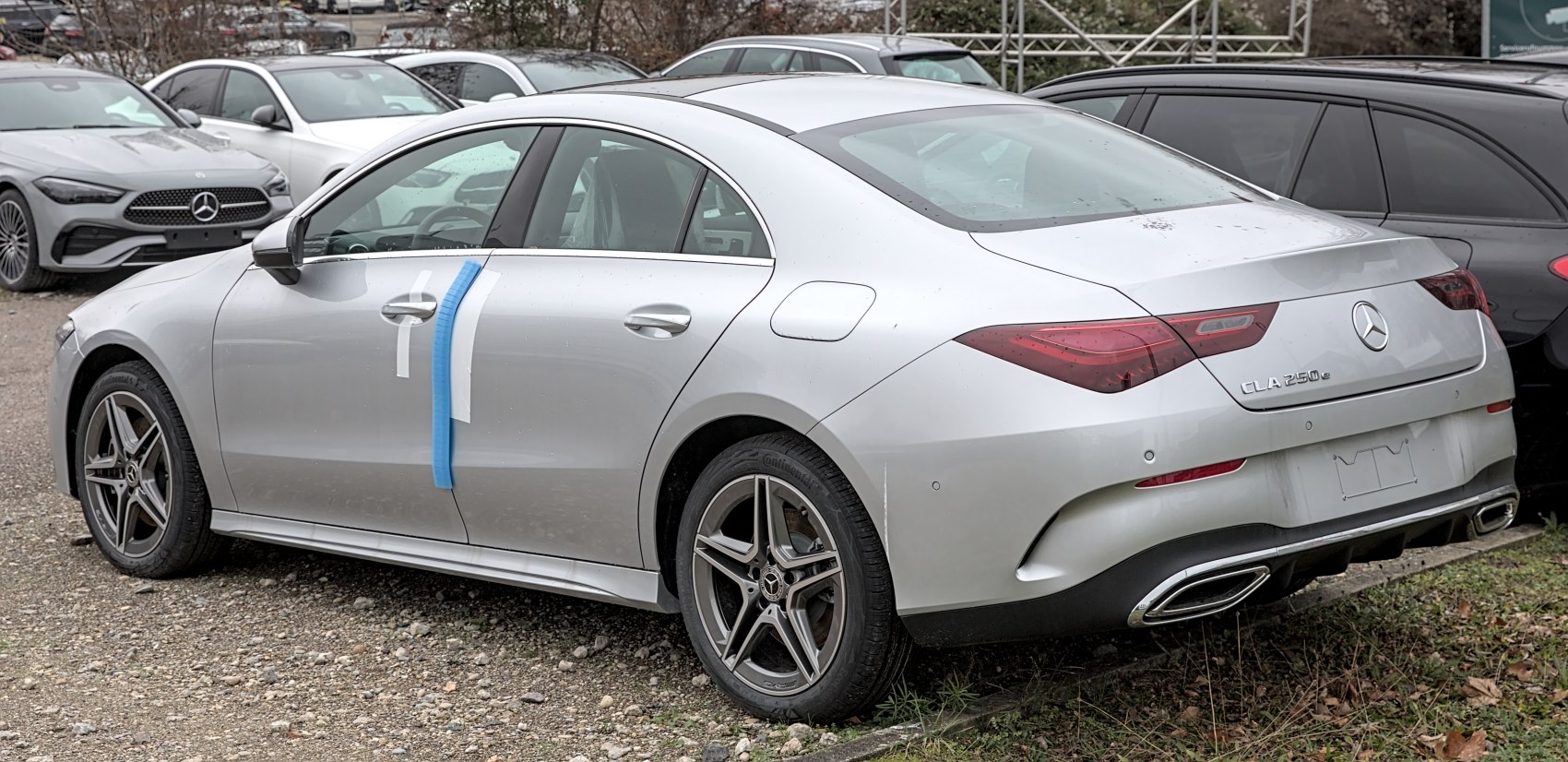 Rear and side view of a sedan with distinctive tail lights, alloy wheels, and dual exhaust