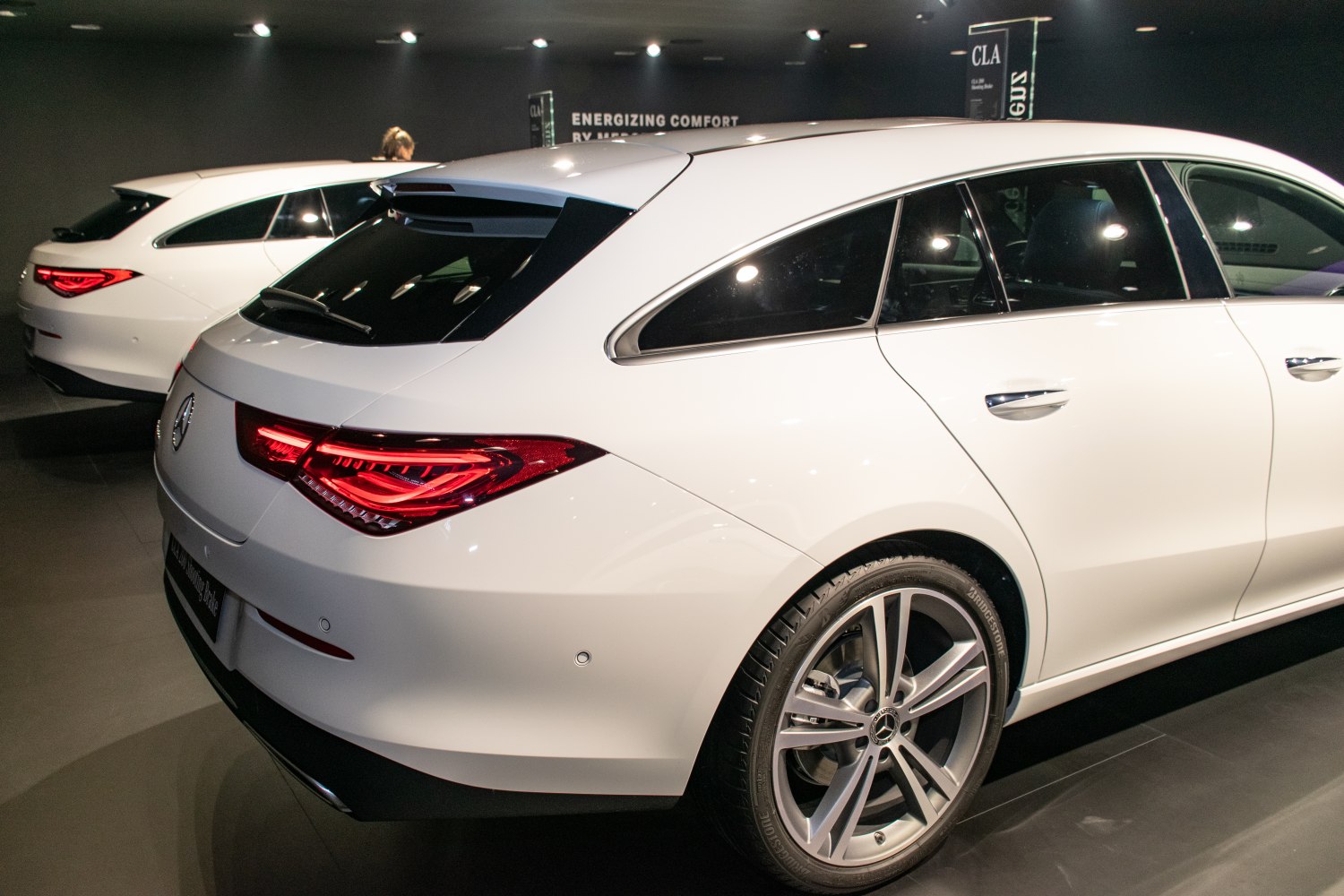 Rear view with distinctive taillights and alloy wheels of a sleek shooting brake vehicle.