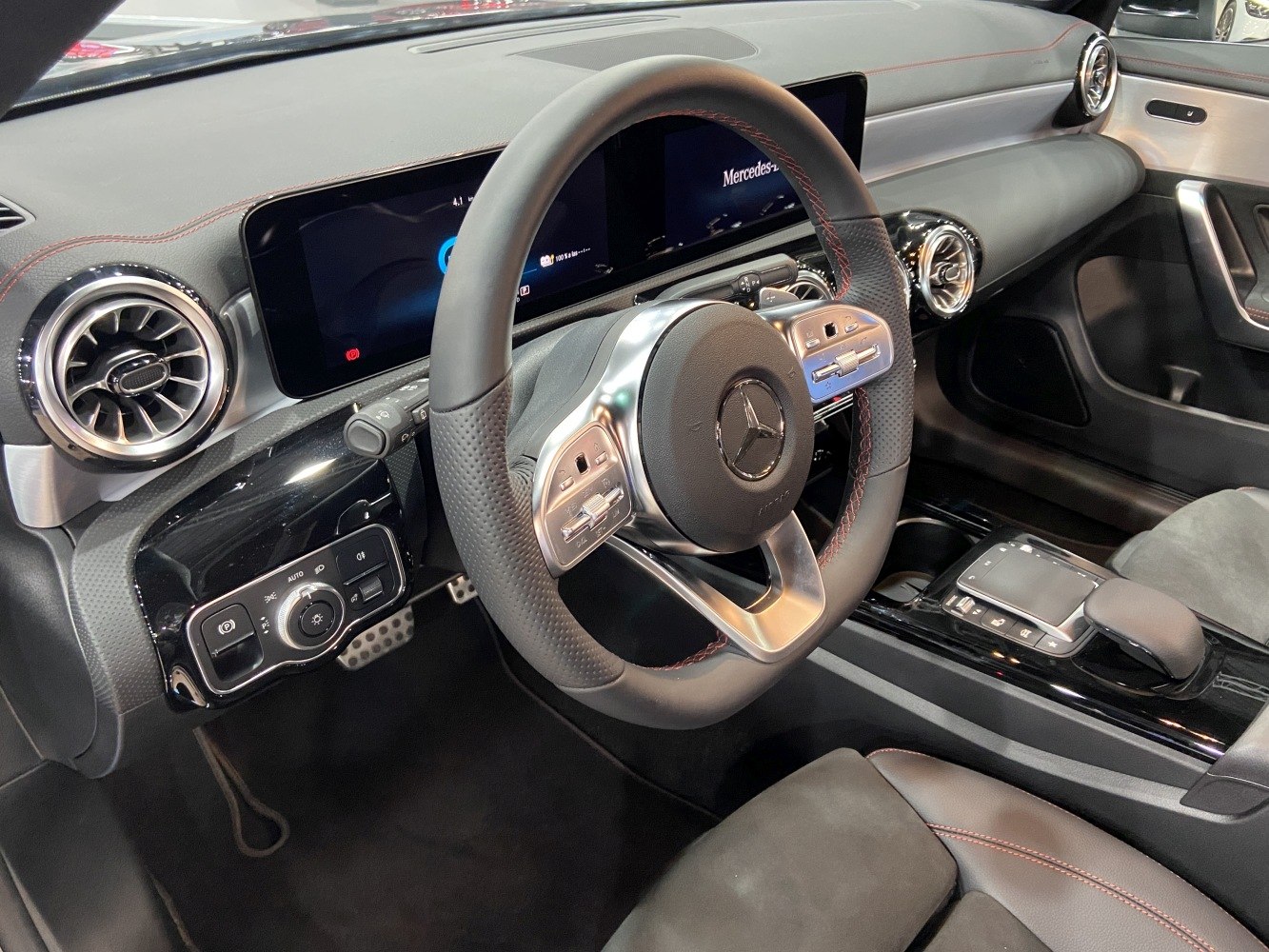 Sporty steering wheel and digital dashboard with turbine air vents