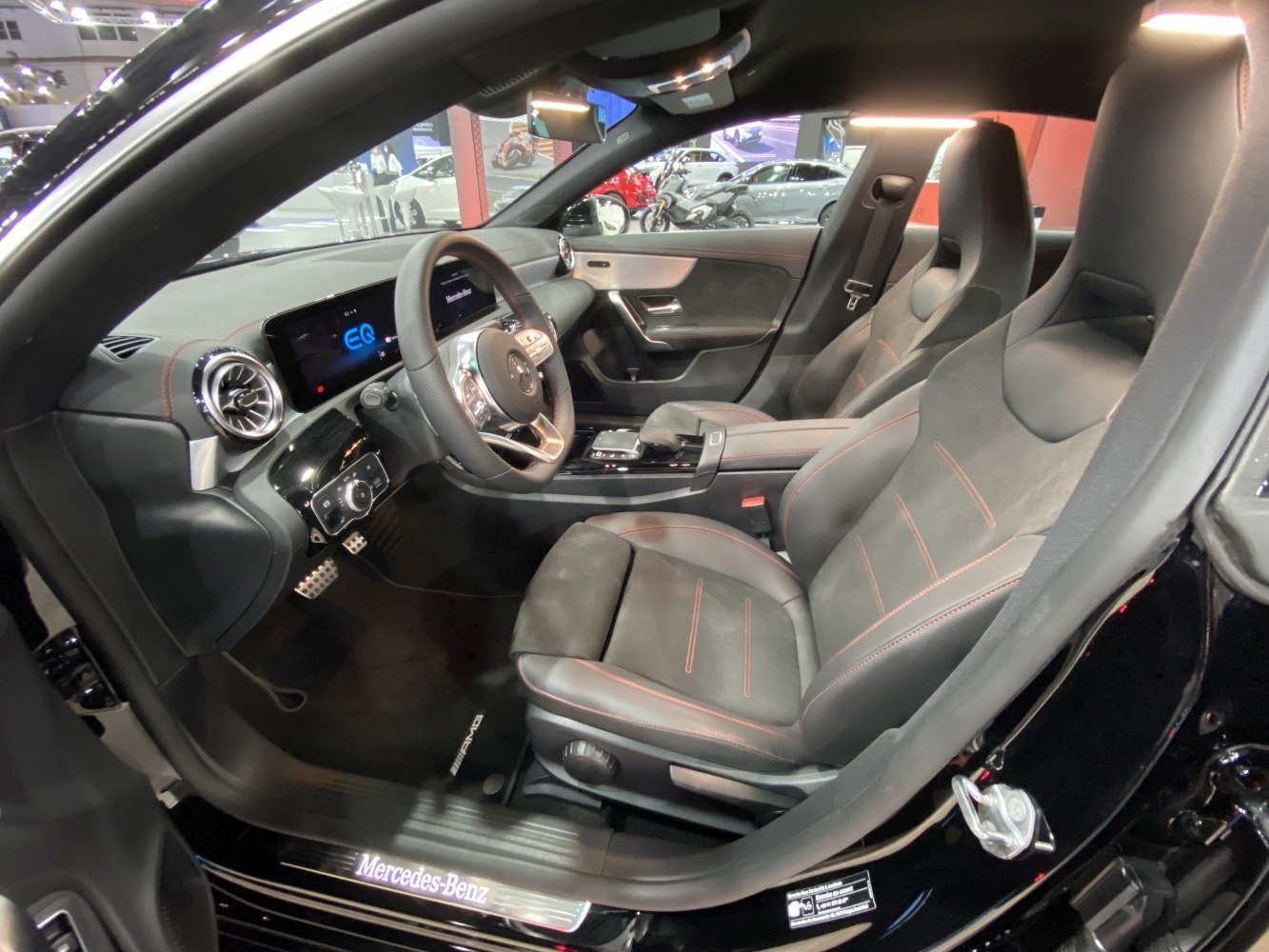 Luxury car interior with digital dashboard and sport seats.