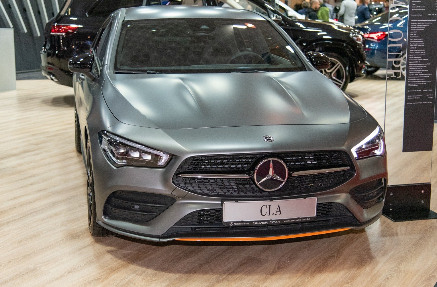 Sporty sedan front with LED headlights and mesh grille