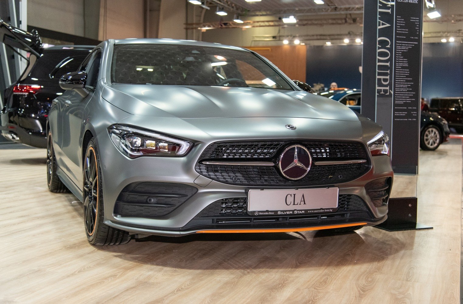 Close-up front view showing LED headlights and bold grille