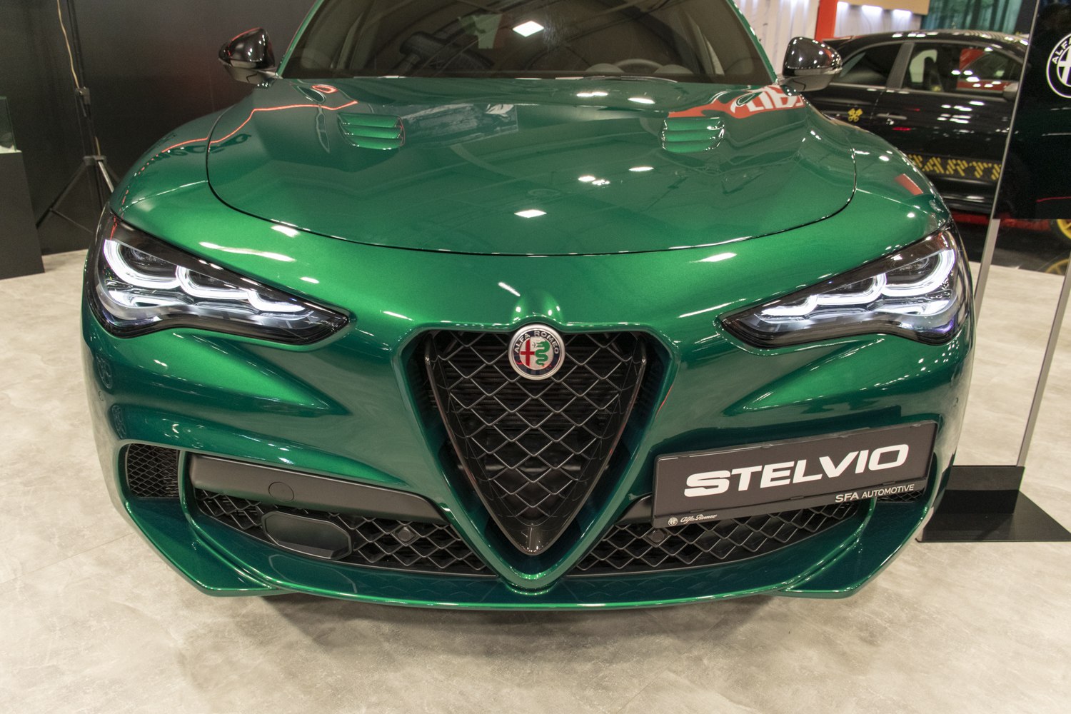 Aggressive headlights and triangular grille on green front fascia
