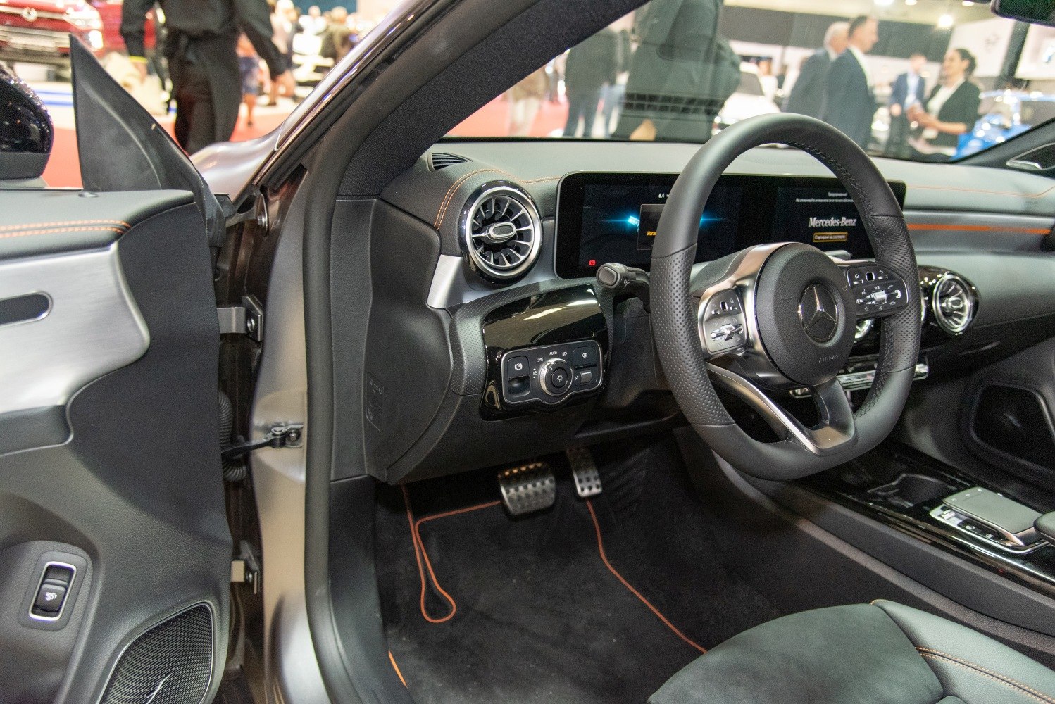 Modern Mercedes-Benz car interior with digital dashboard and advanced steering controls