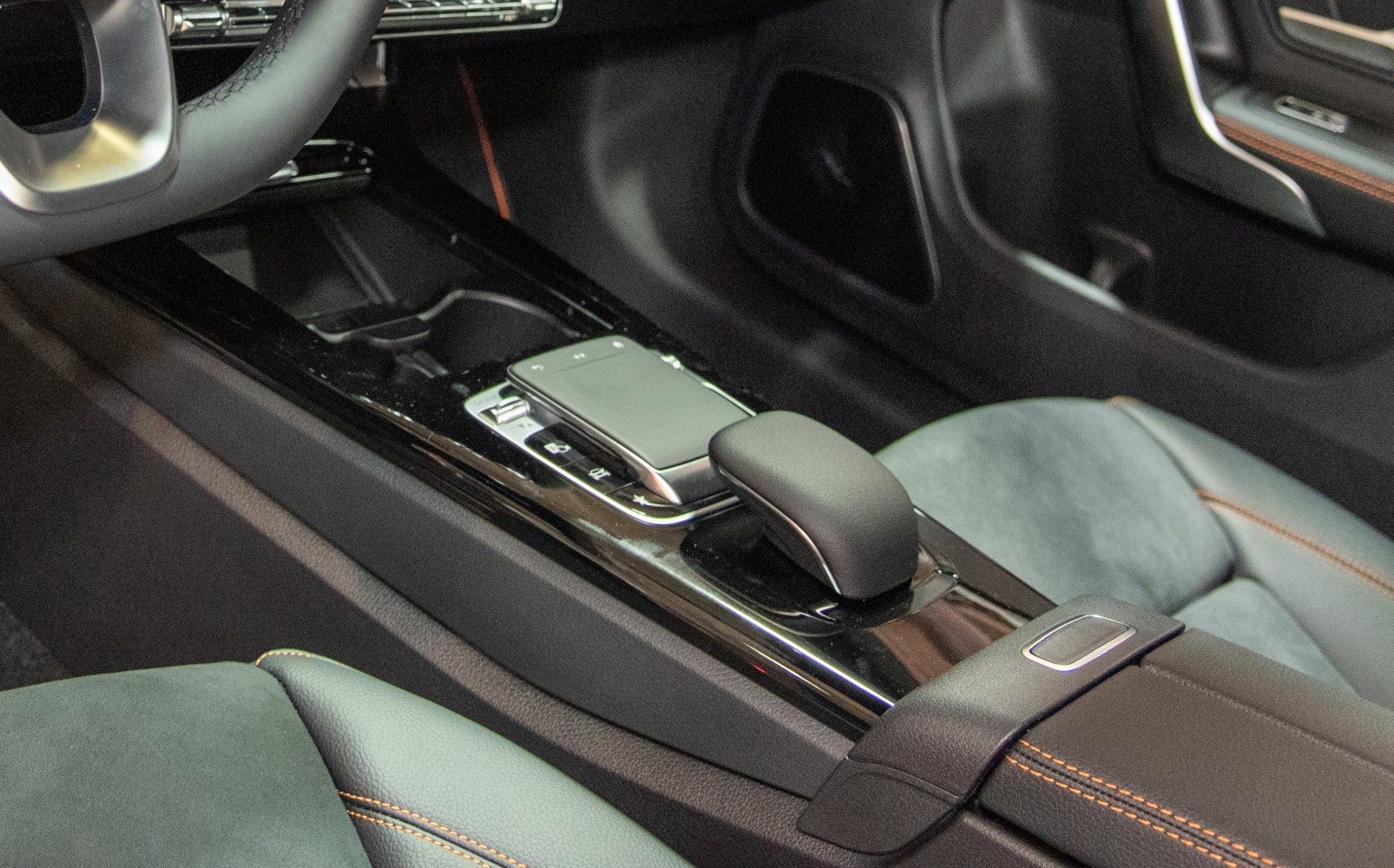 Center console with gear shift and control touchpad in luxury car interior