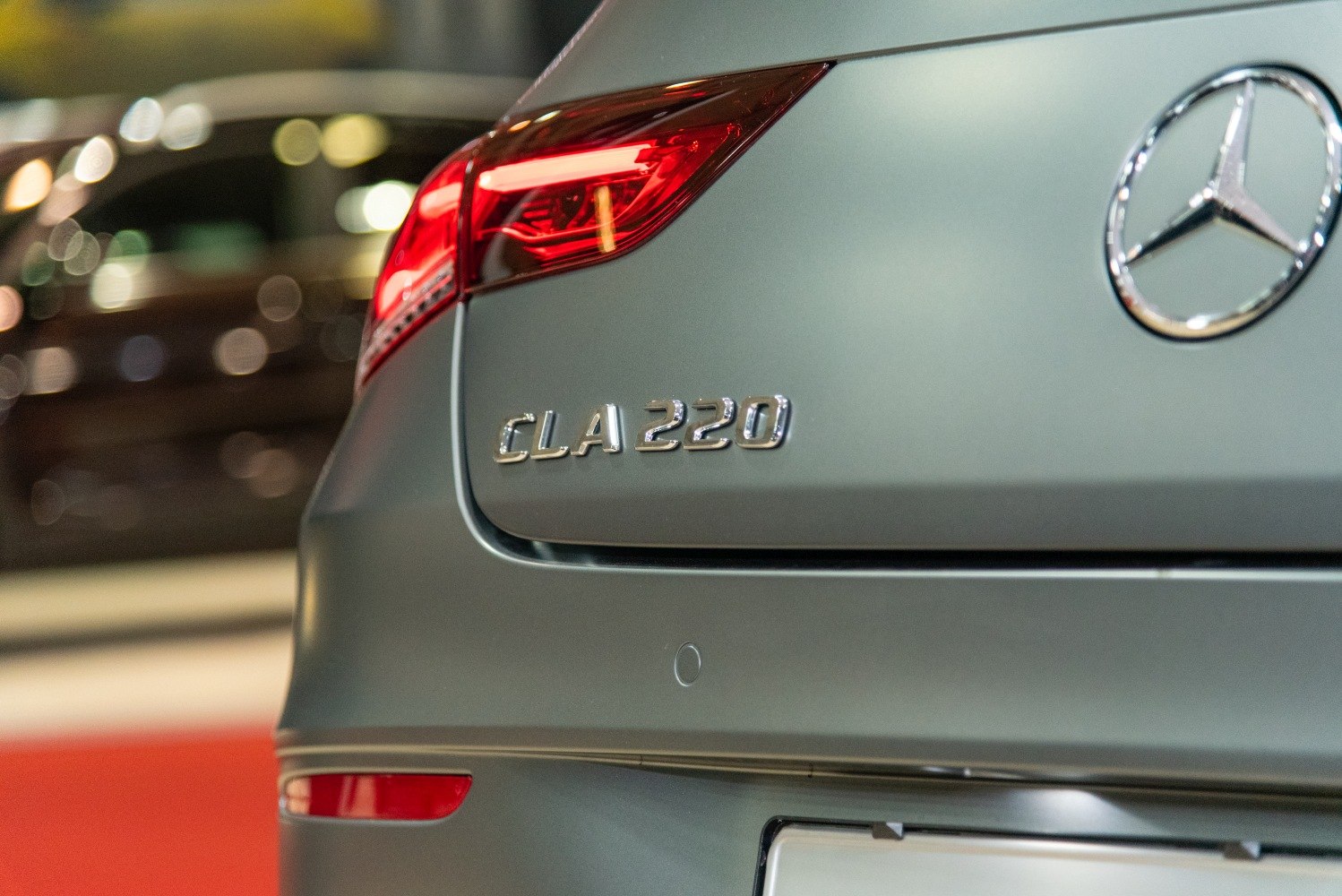 Close-up of rear badge and tail light assembly on modern coupe
