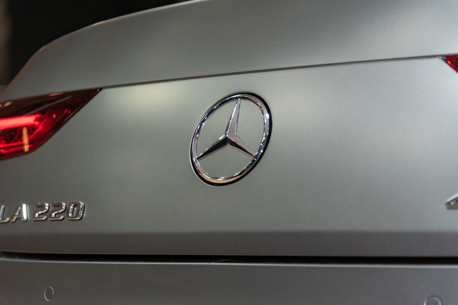 Close-up of rear Mercedes-Benz star emblem and CLA 220 badge