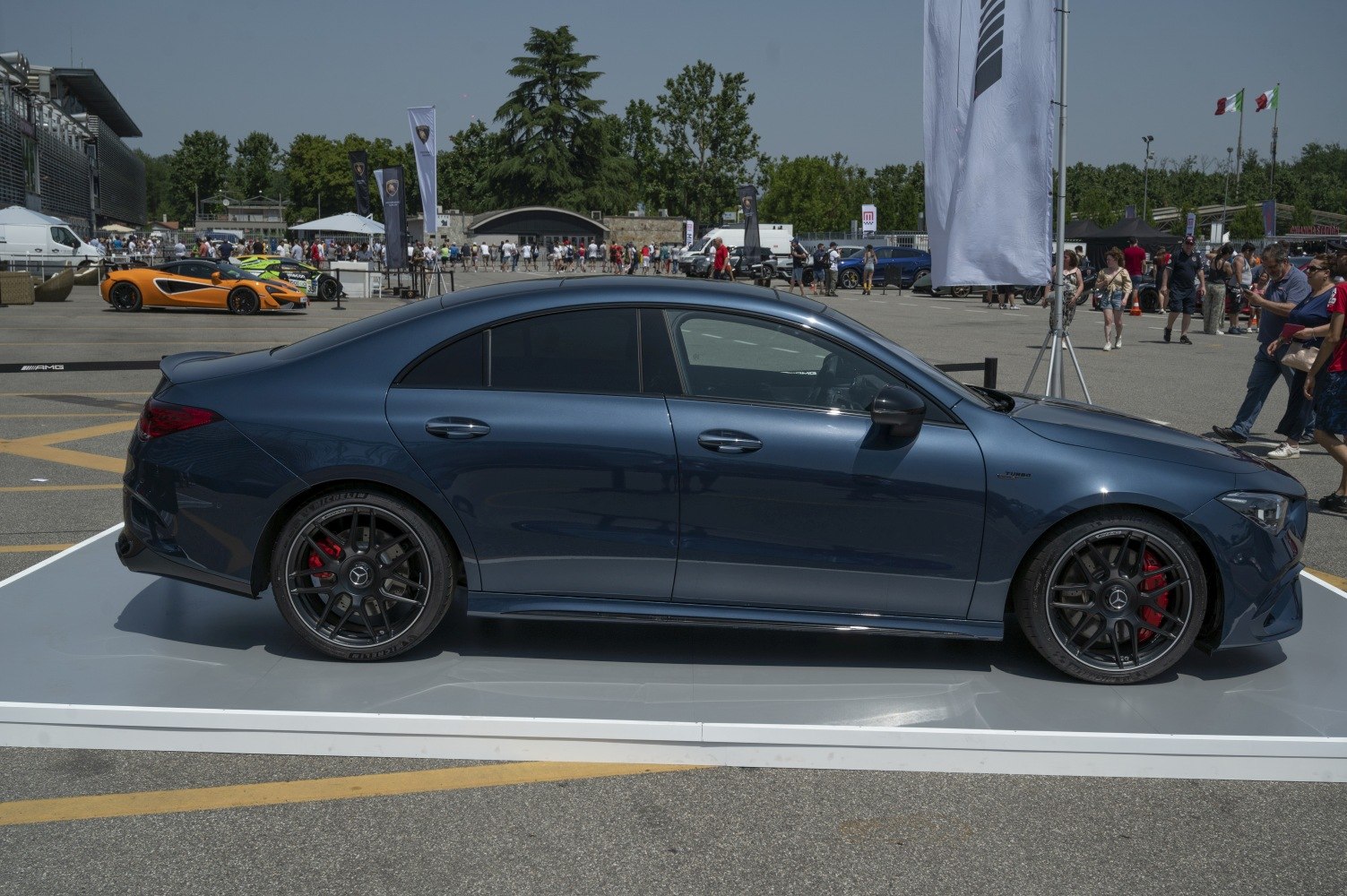 Side profile of a luxury sedan with AMG wheels and red brake calipers
