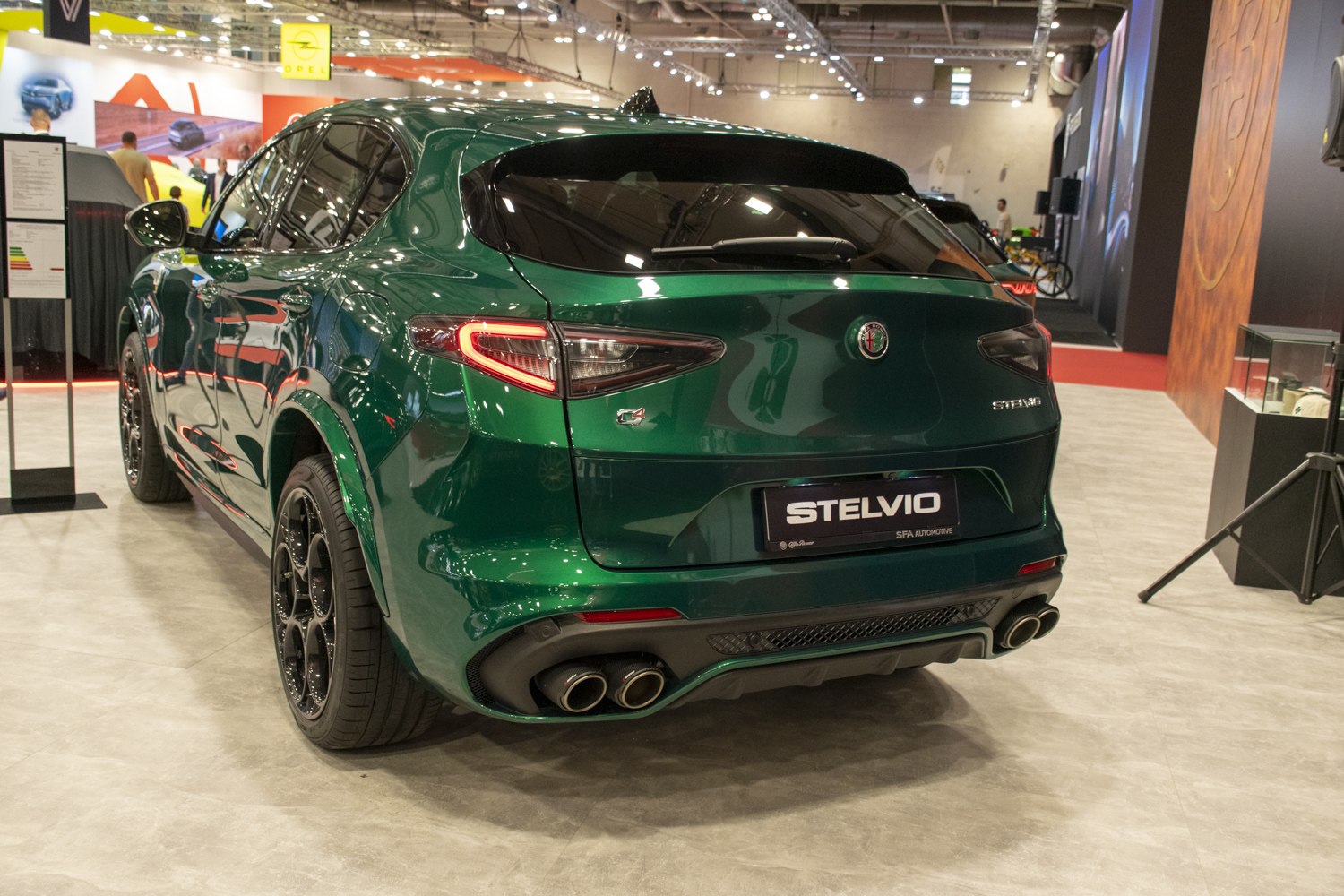 Rear view of green SUV with quad exhaust and sleek sporty taillights