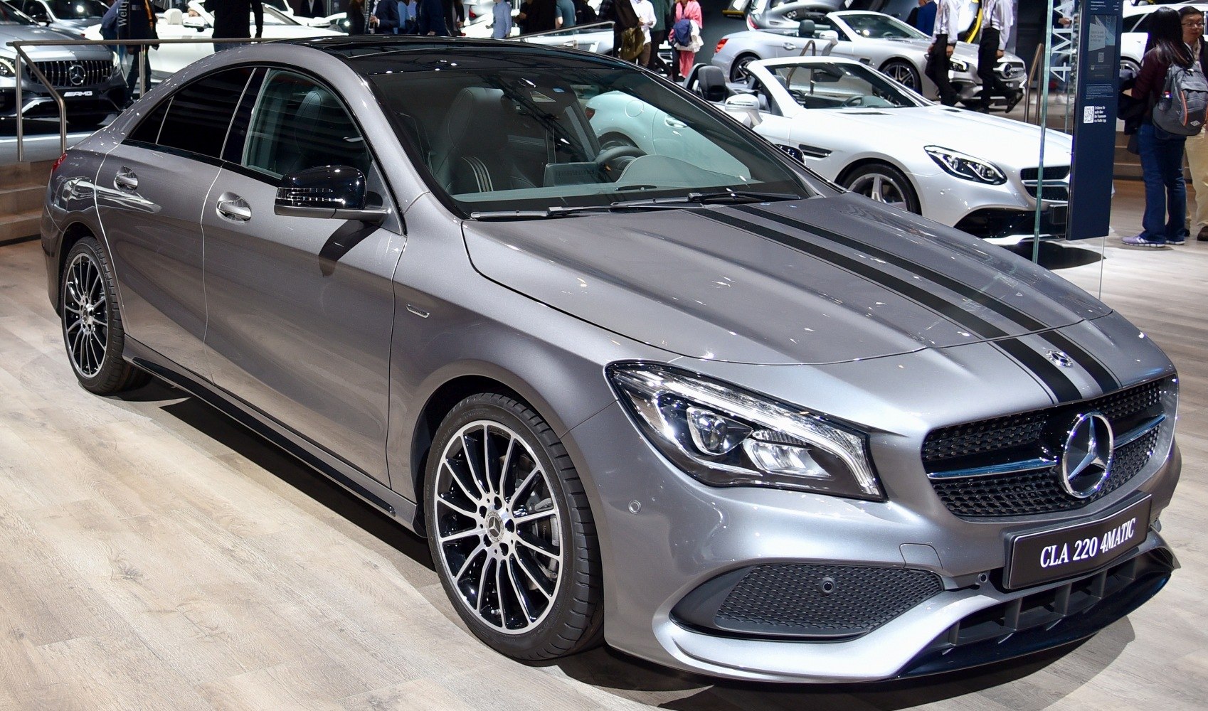 Front-side view with racing stripes and multi-spoke alloy wheels