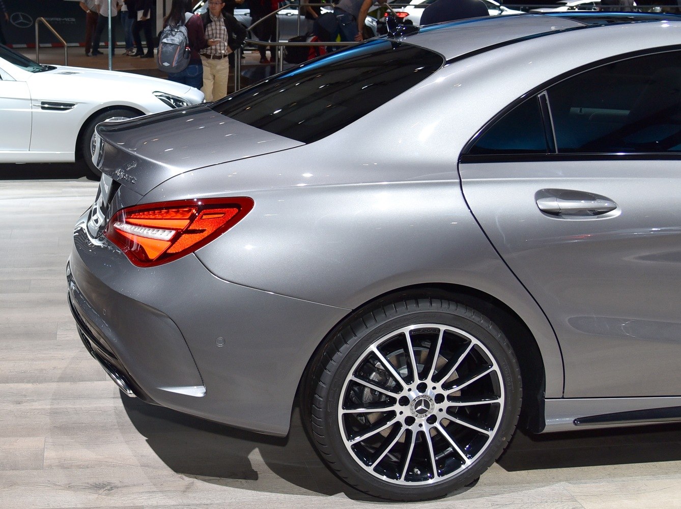 Rear car section with distinctive taillight and multi-spoke alloy wheel