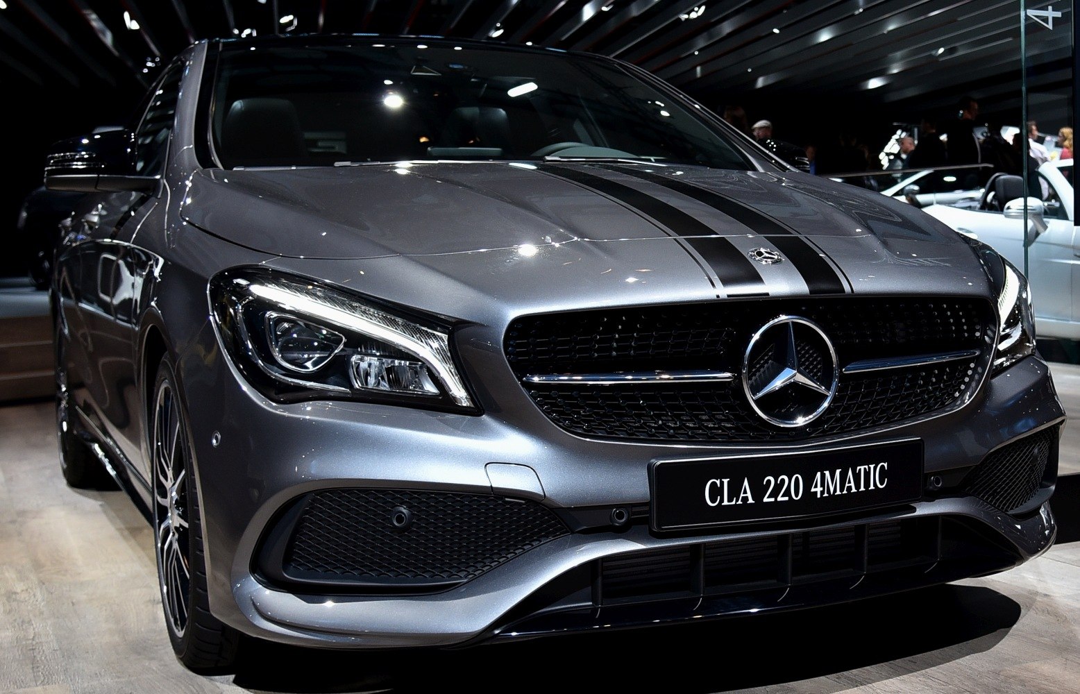 Front headlight and grille with racing stripes on a luxury coupe