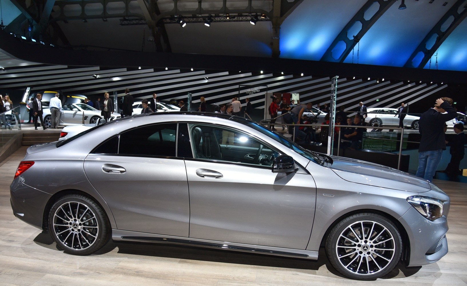 Silver sporty coupe side profile with black multi-spoke rims